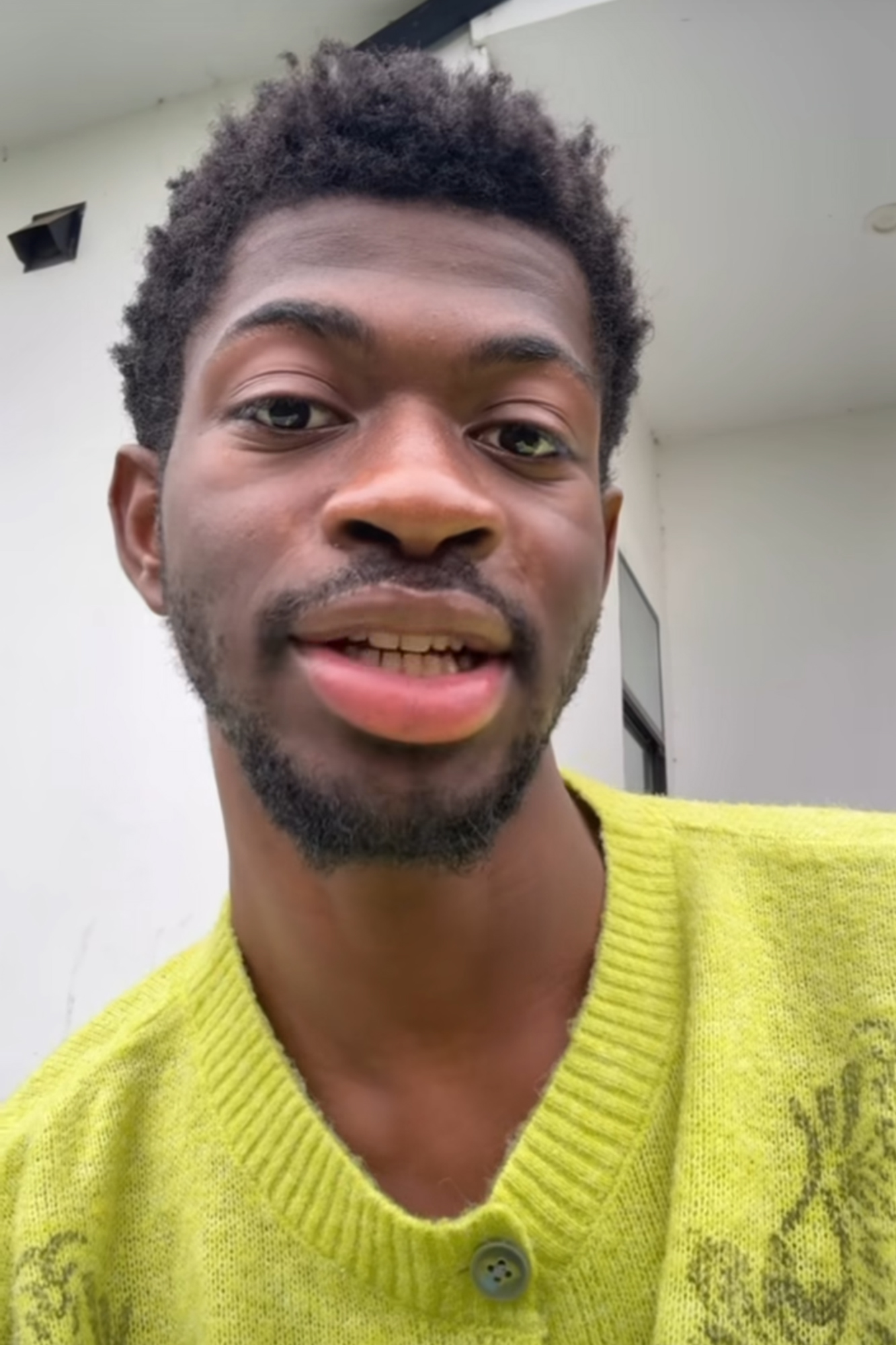 Lil Nas X looks at a camera. 