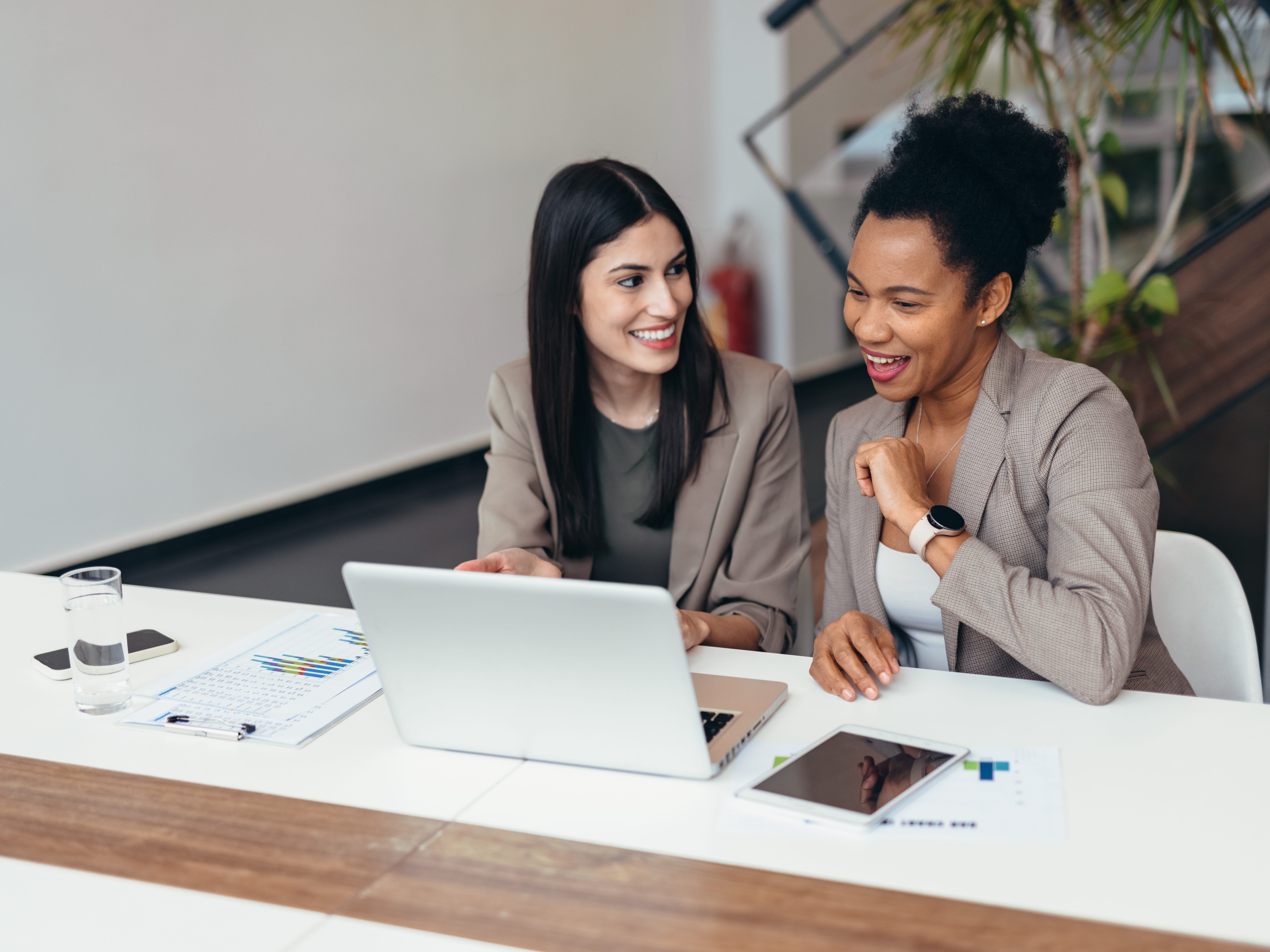 Two people looking at a laptop