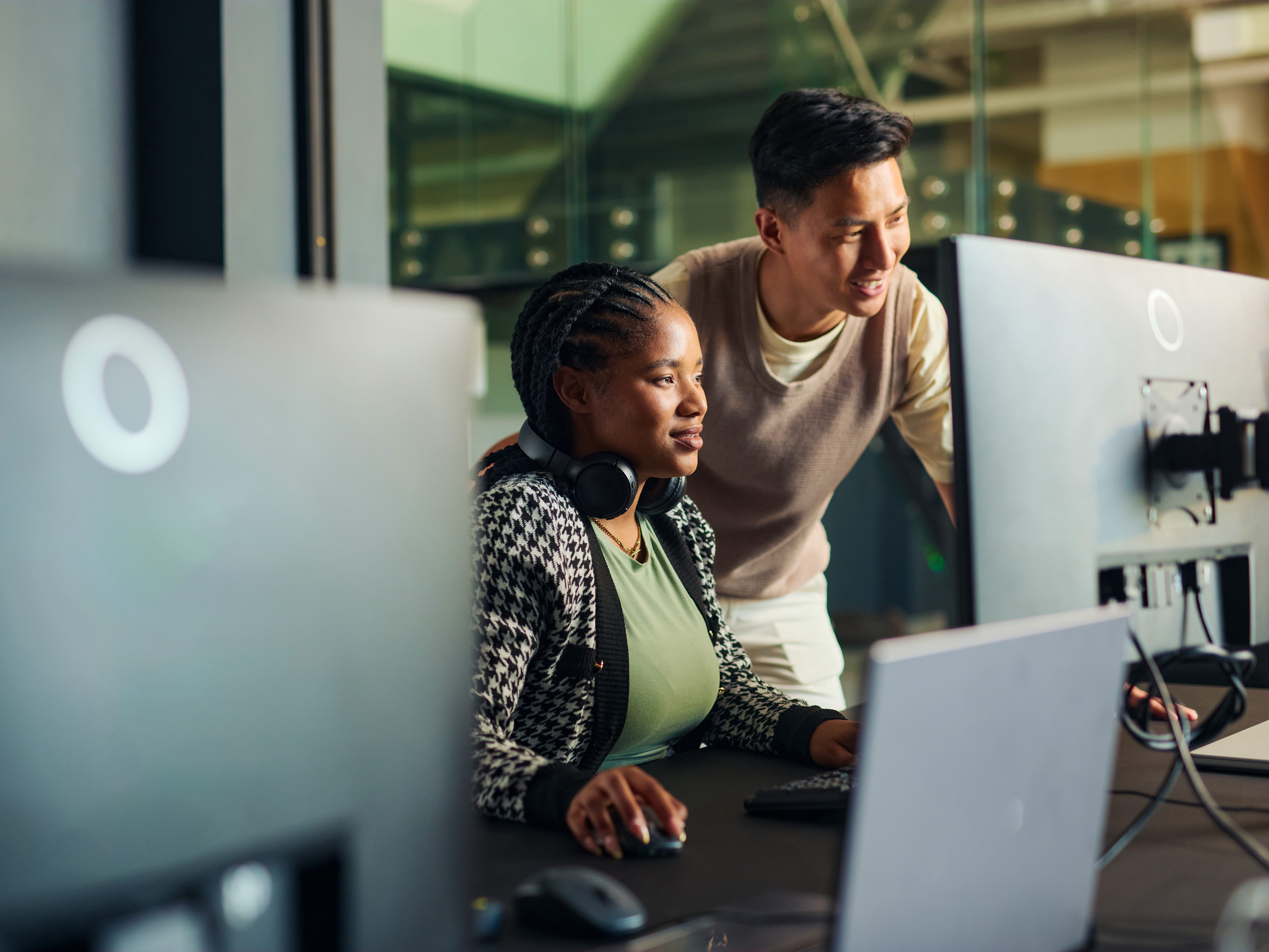 Two people looking at a computer