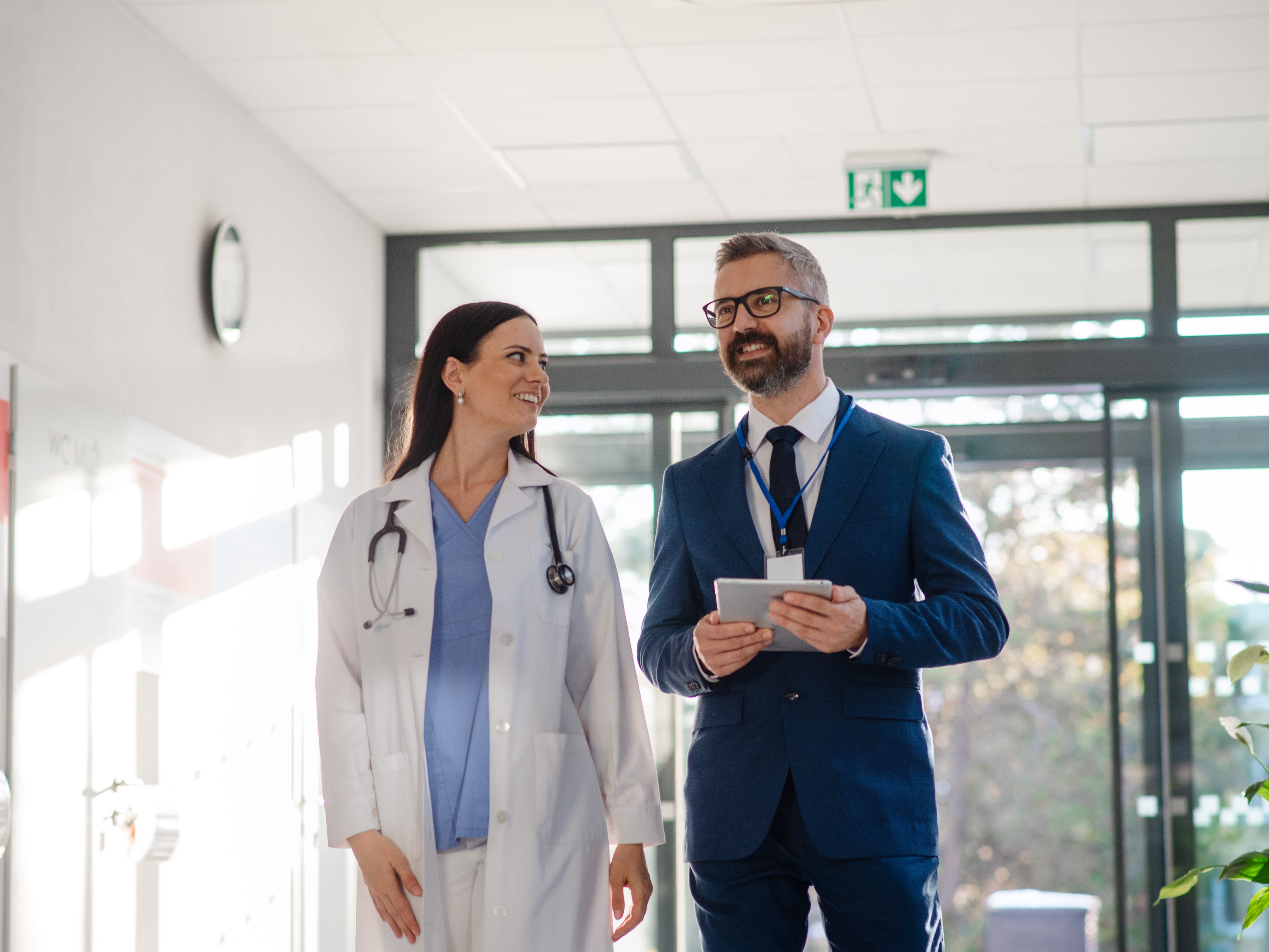 A doctor walking with a businessman