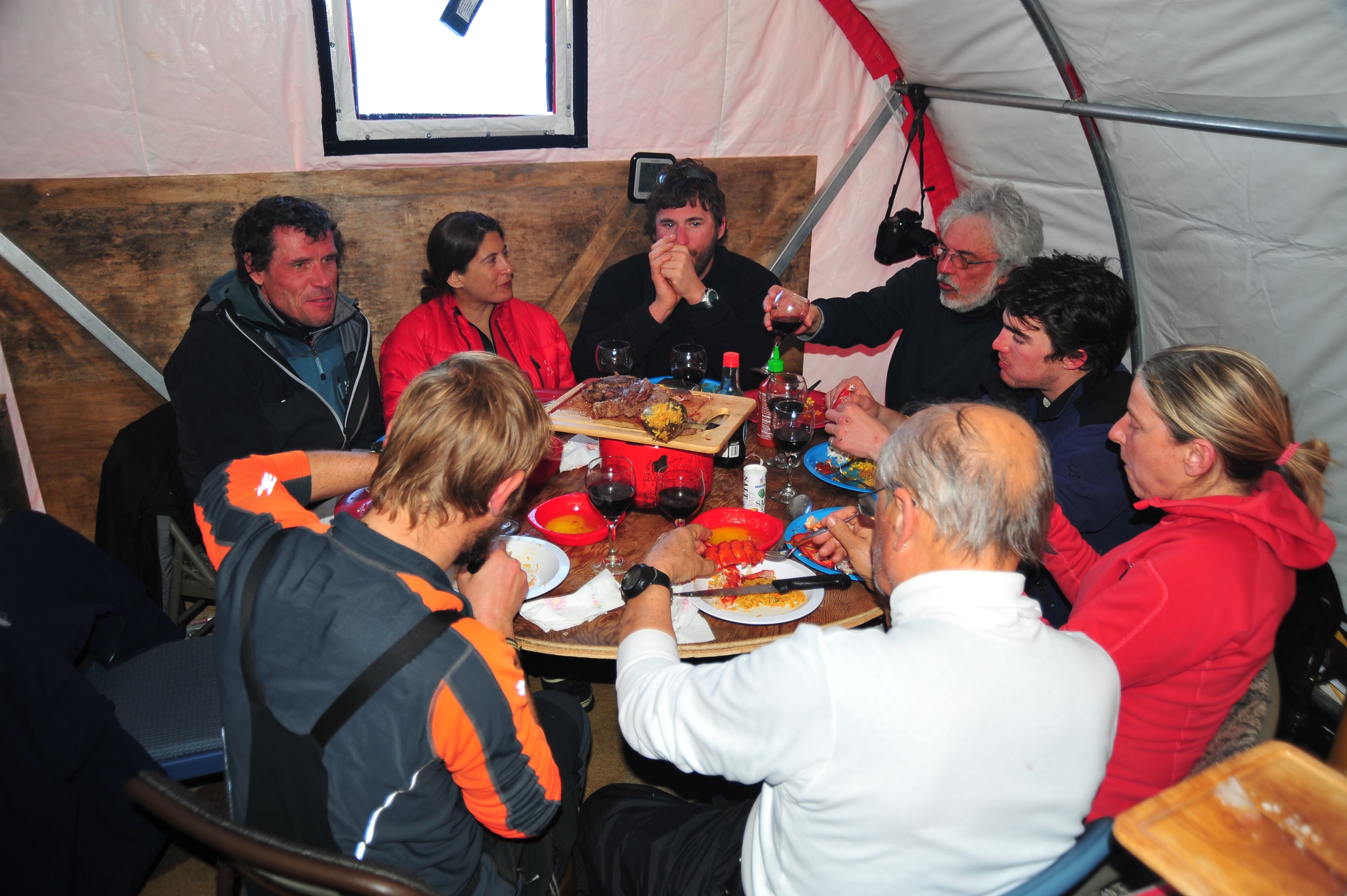 The crew and visitors eat steak and lobsters with wine in one of the Swiss Camp tents in 2011