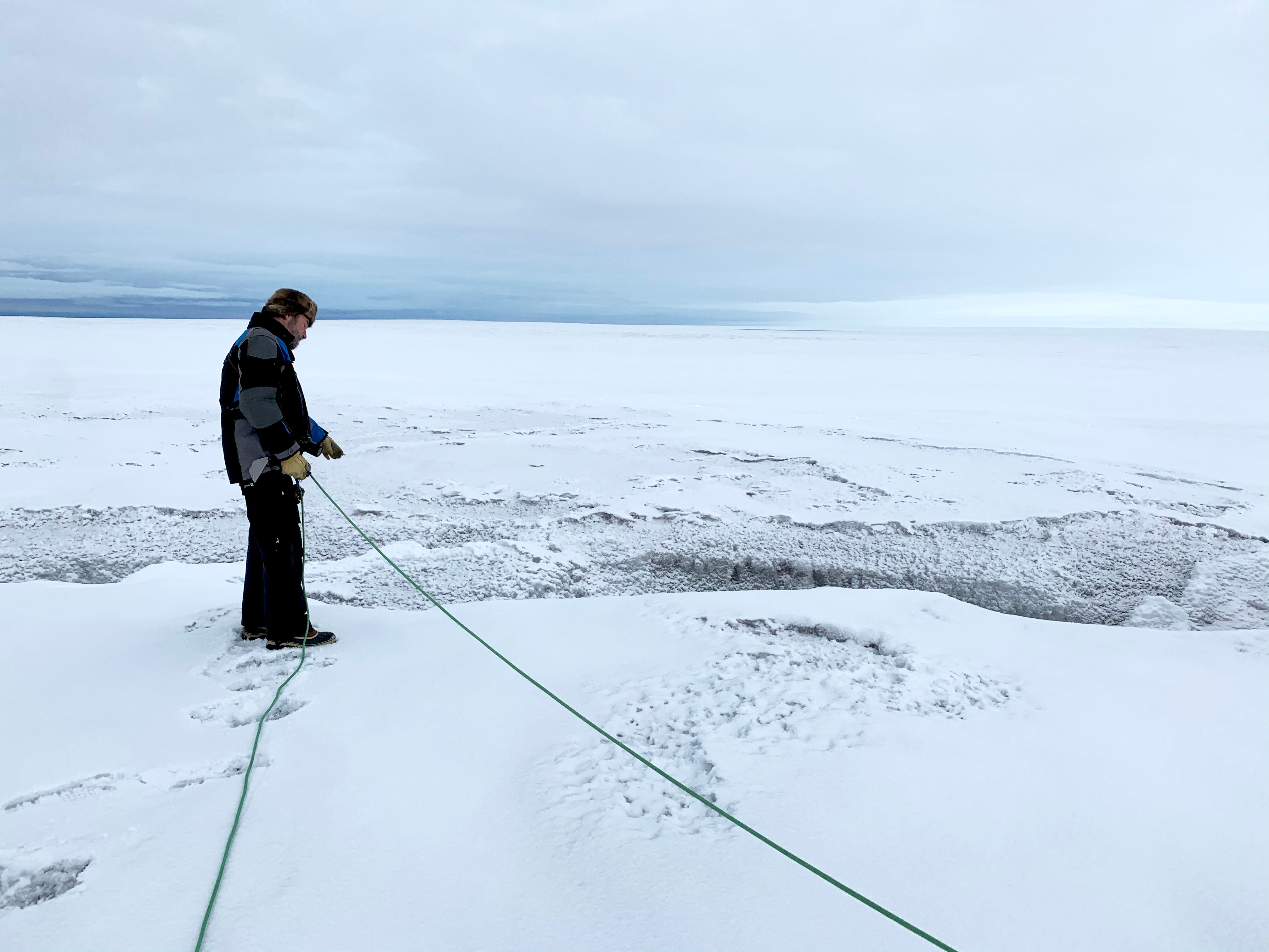 Koni surveys a crevasse. They are often difficult to see in the snow.