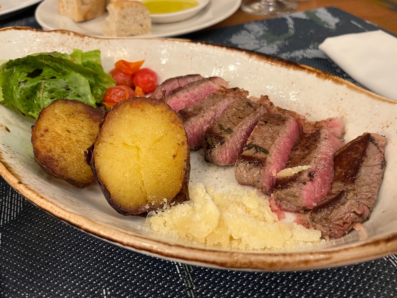 Sliced steak and potatoes on plate