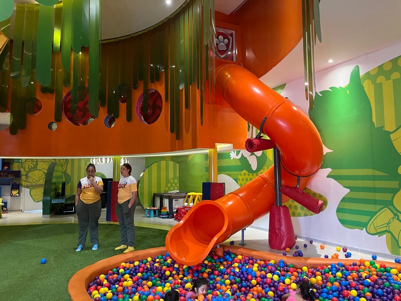 Twisted orange slide leading to ball pit