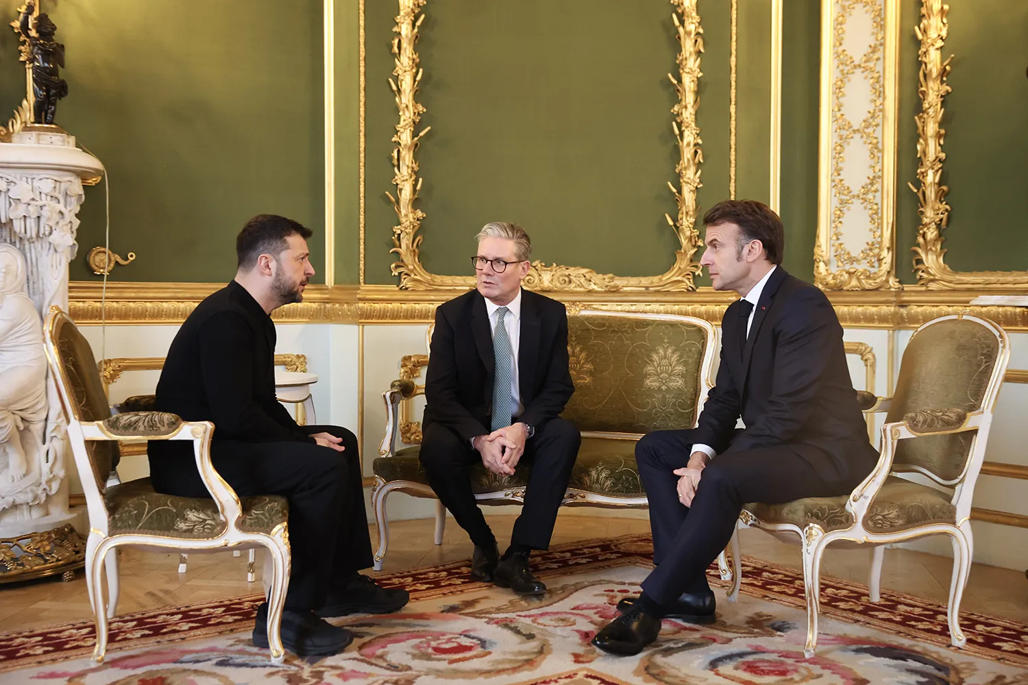 British Prime Minister Keir Starmer, center, speaks with Ukrainian President Volodymyr Zelensky, left, and French President Emmanuel Macron as he hosts a European leaders’ summit at Lancaster House in London.