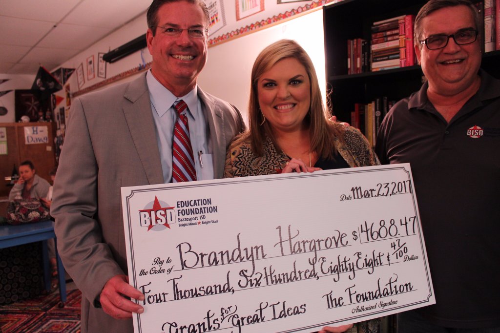 Brandyn Hargrove receiving a check