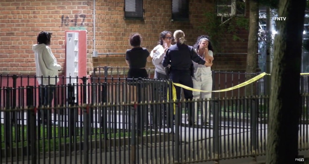 Police and bystanders at a crime scene.