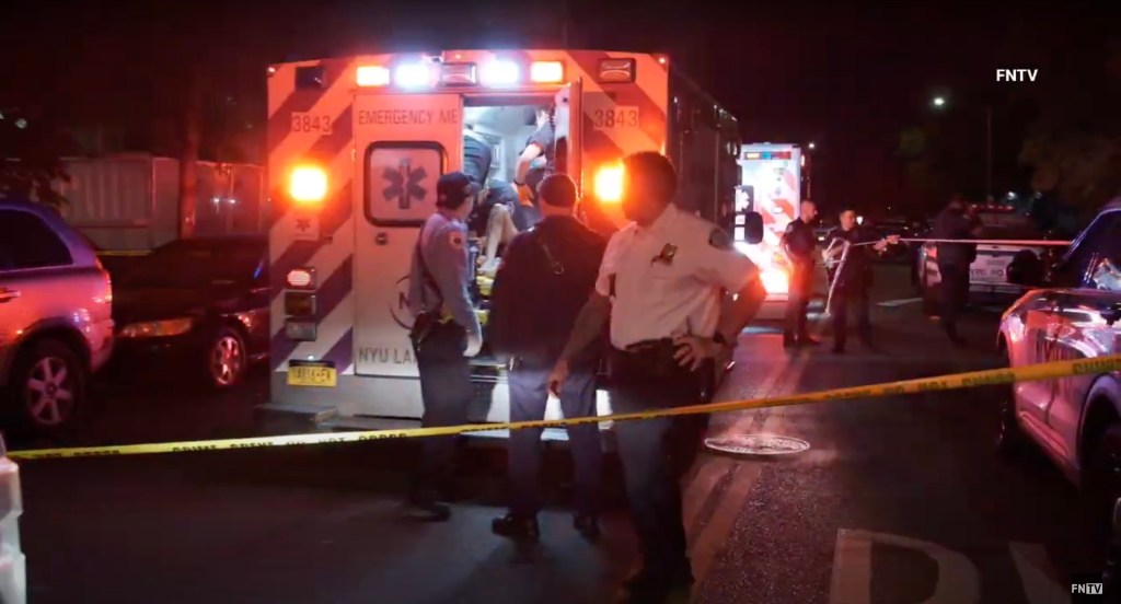 Emergency responders attending to three shooting victims.