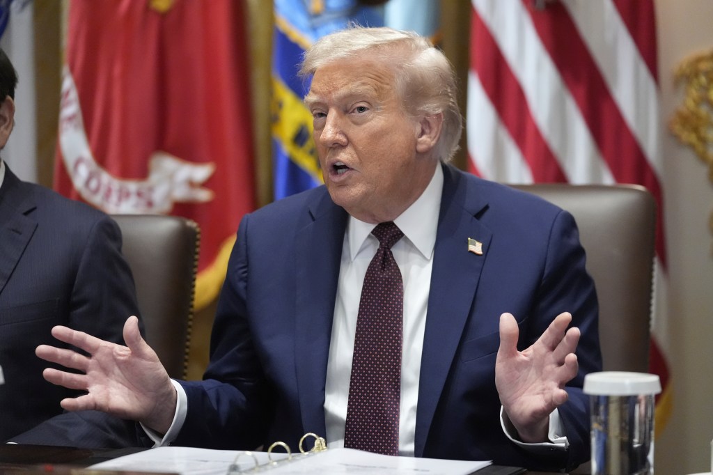 Donald Trump speaking at a meeting.