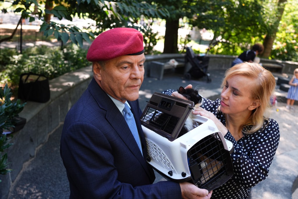 Curtis Sliwa, founder of the Guardian Angels, with his wife and cat at a playground.
