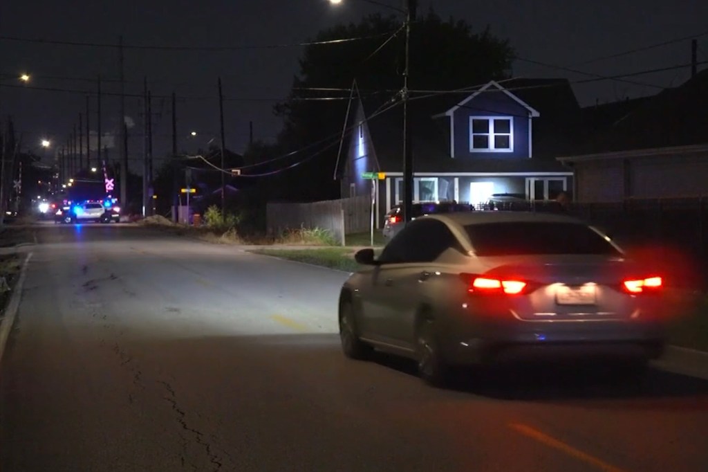 Police cars at night on a residential street.