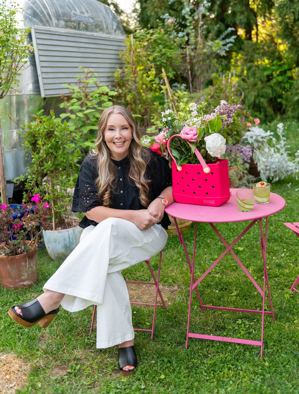 Kim Vaccarella, founder and CEO of Bogg seated with a bag from her company.