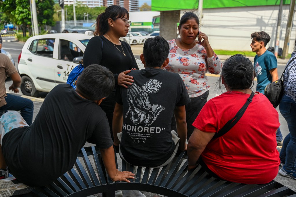 A Guatemalan family sits on a bench after a deportation from the United States.