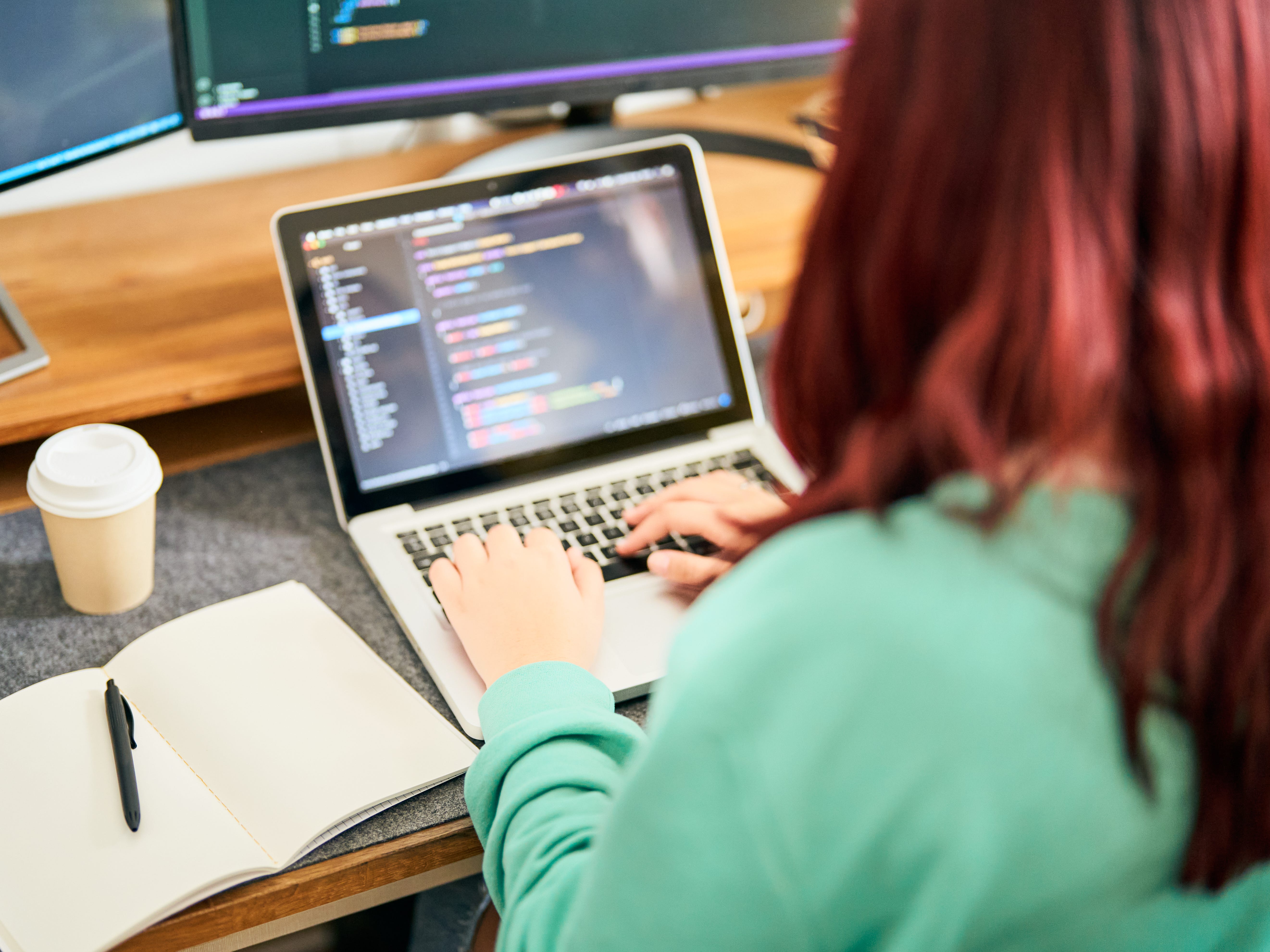 Person working on code on a laptop