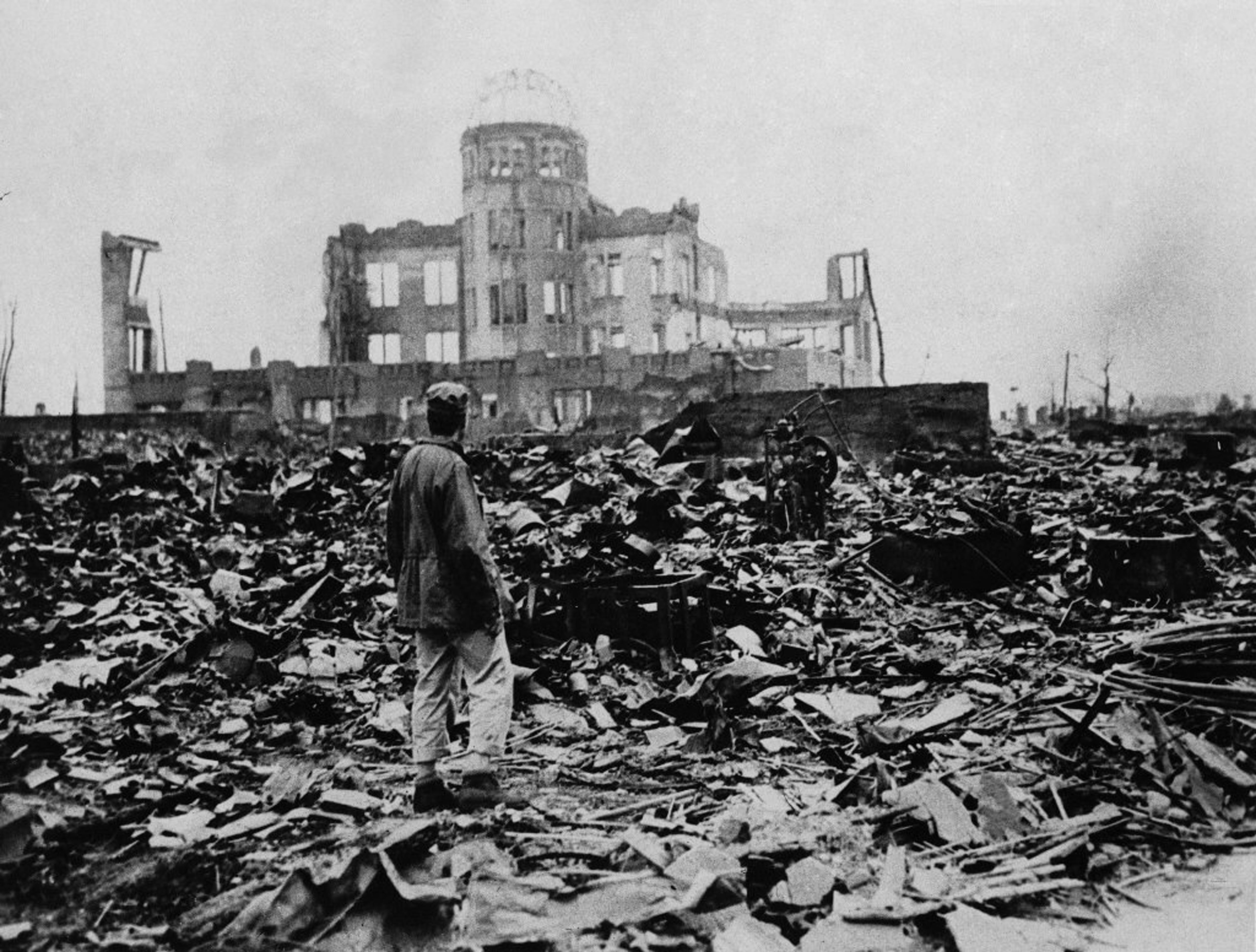 A man stands in front of a destroyed dome after the atomic bomb was dropped on Hiroshima, Japan, in 1945.