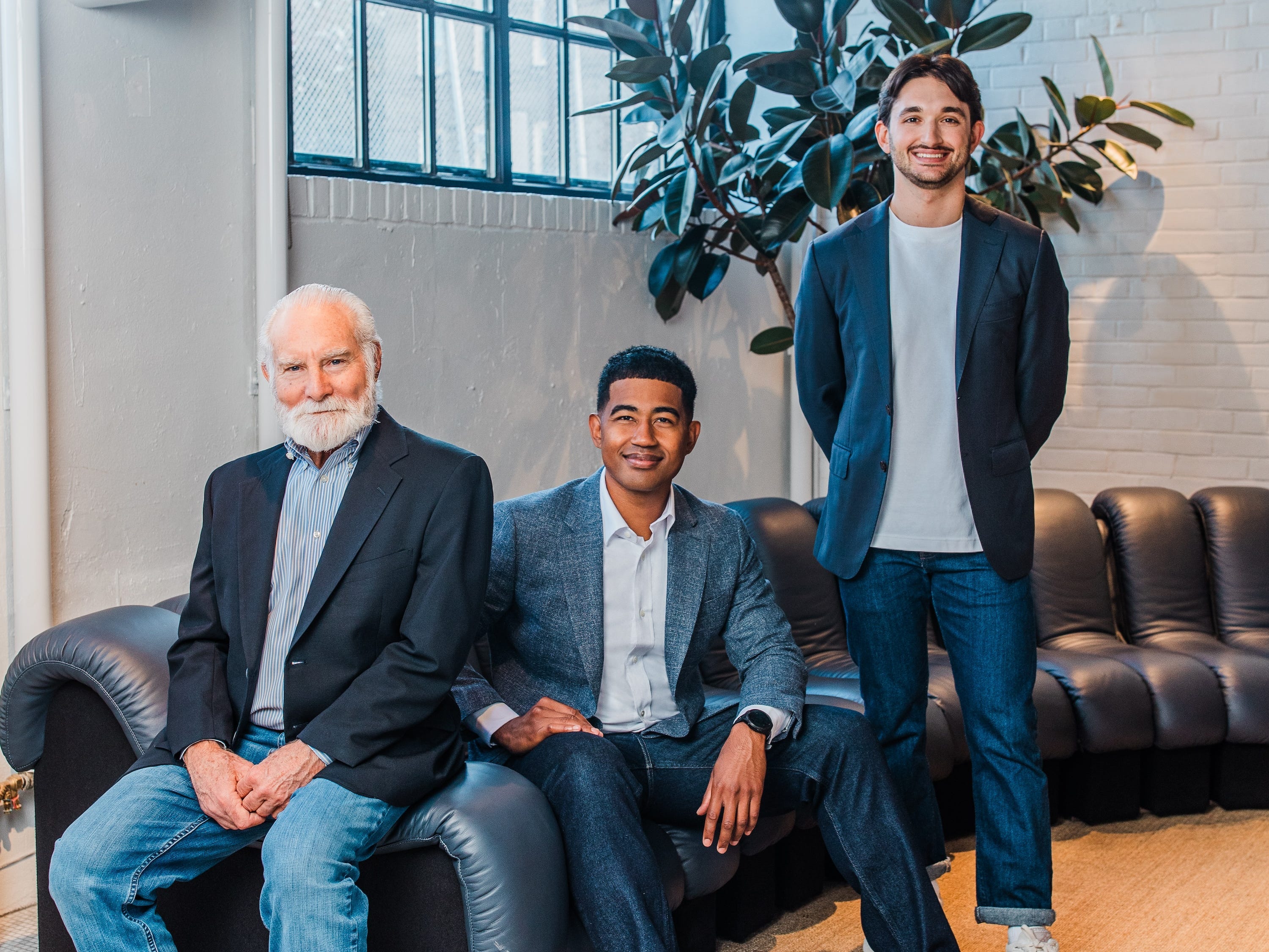 Three men of mixed ages and races pose for a professional headshot.