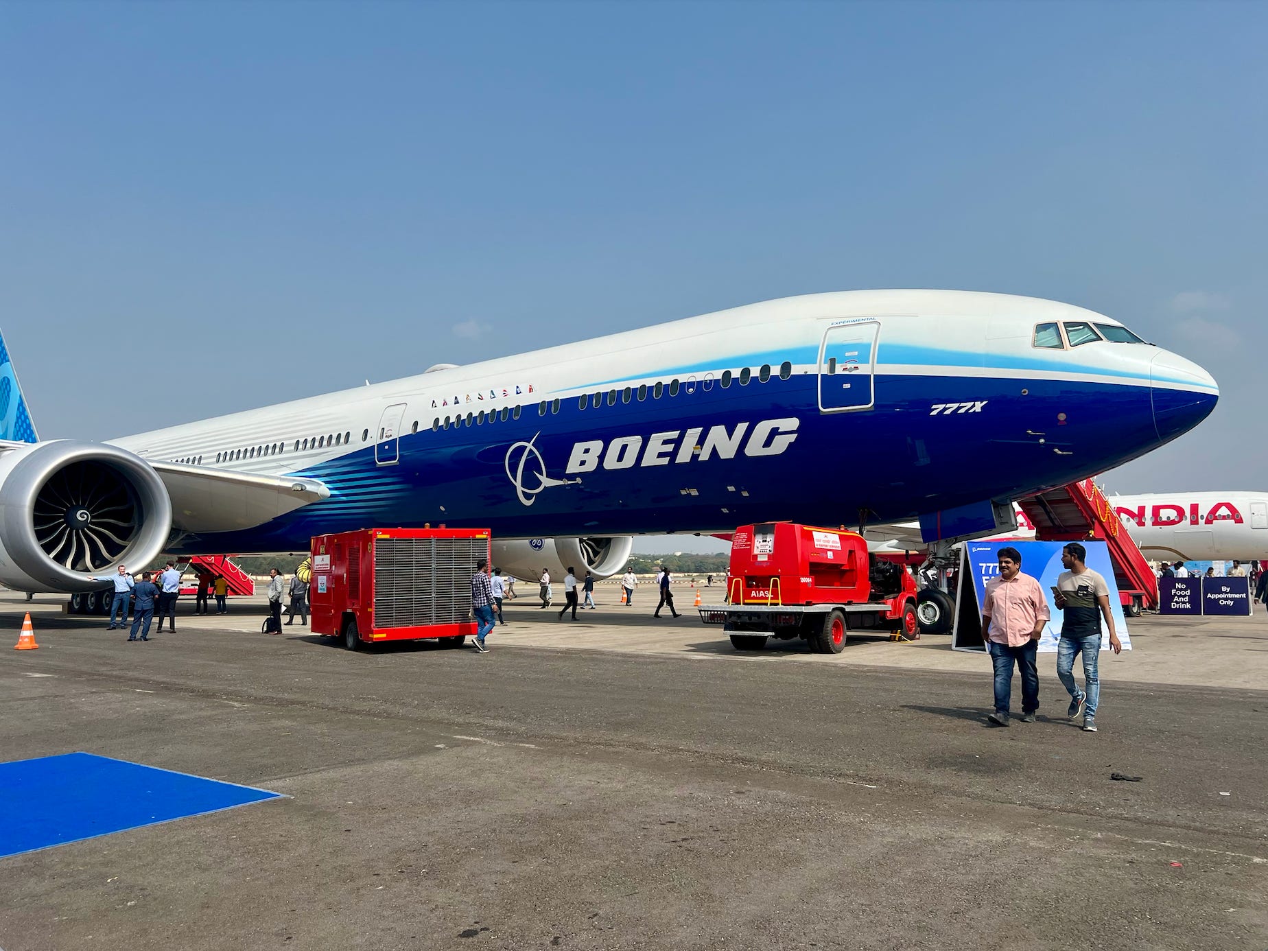 A Boeing 777X plane on display at an airshow.