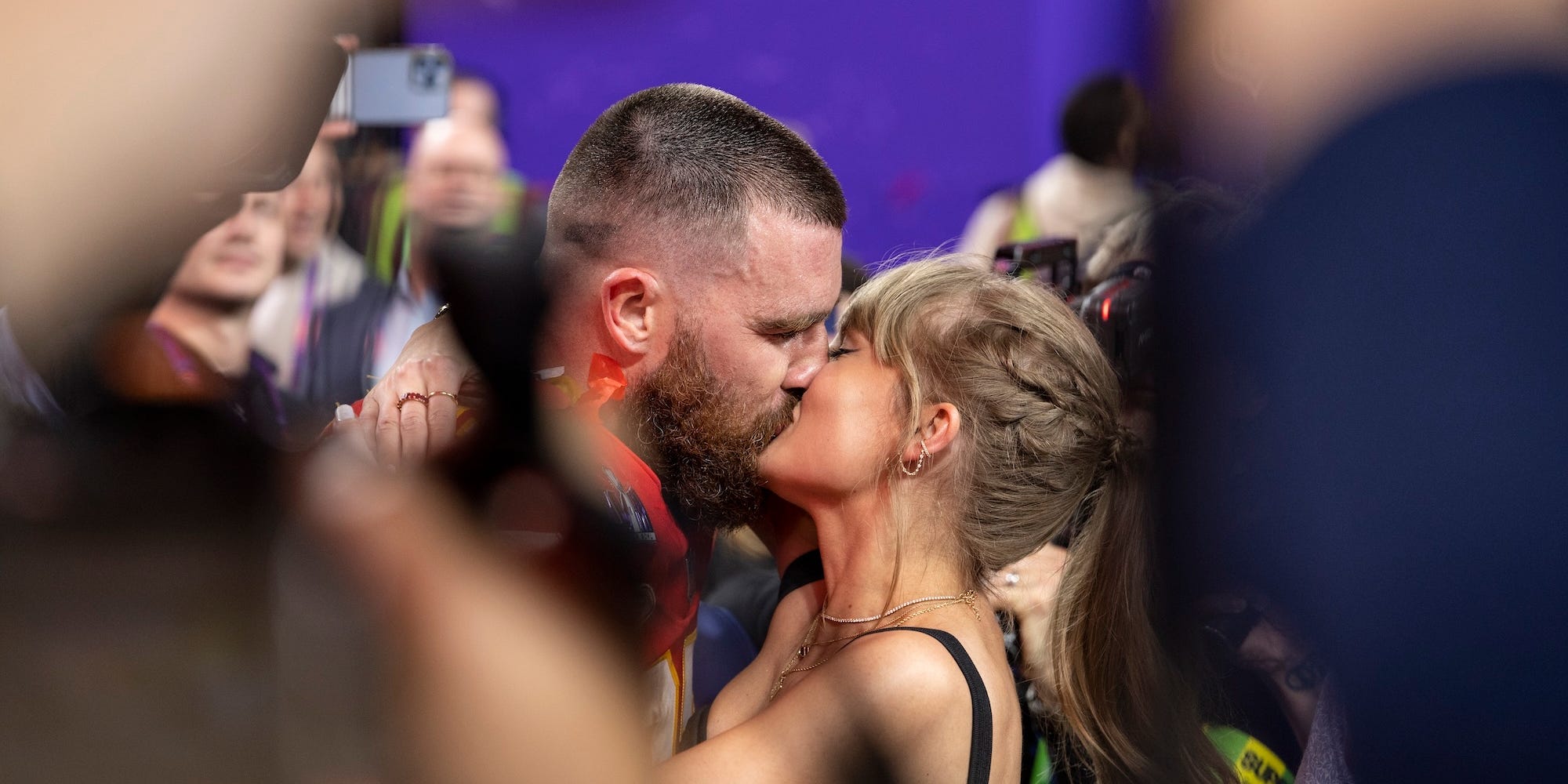 Travis Kelce kisses Taylor Swift following Super Bowl win.