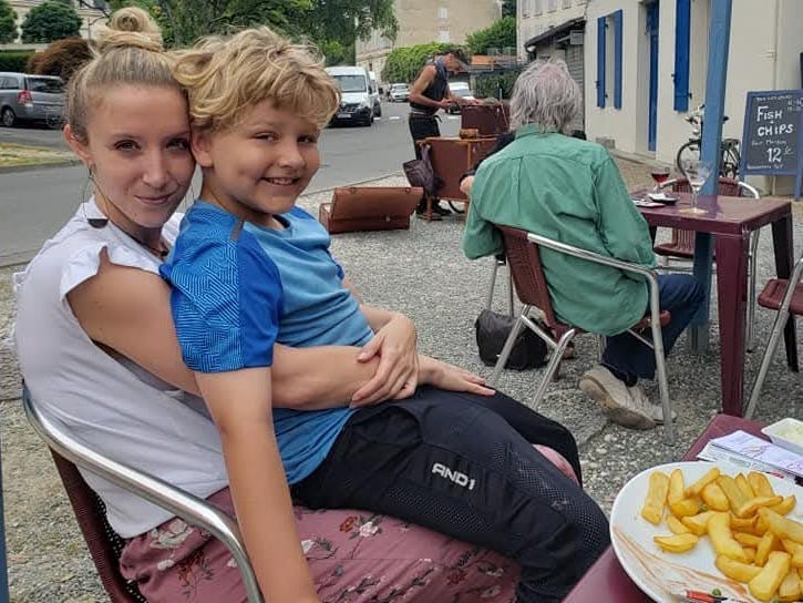 The author and her son sit an an outdoor cafe.