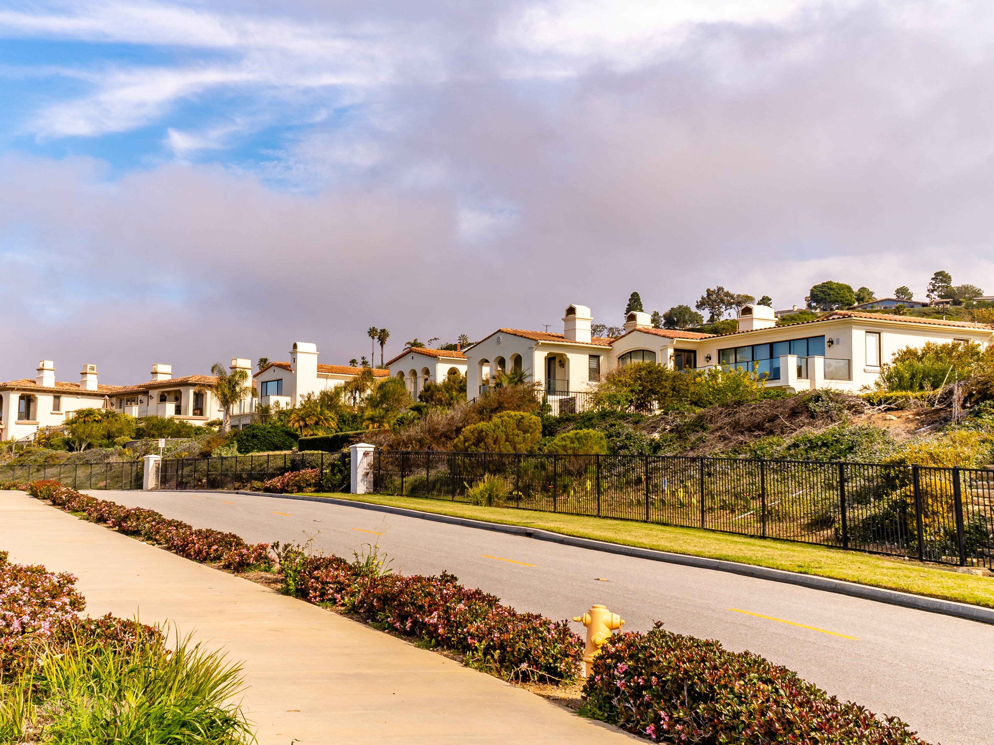 Spanish-style houses line a road in California.