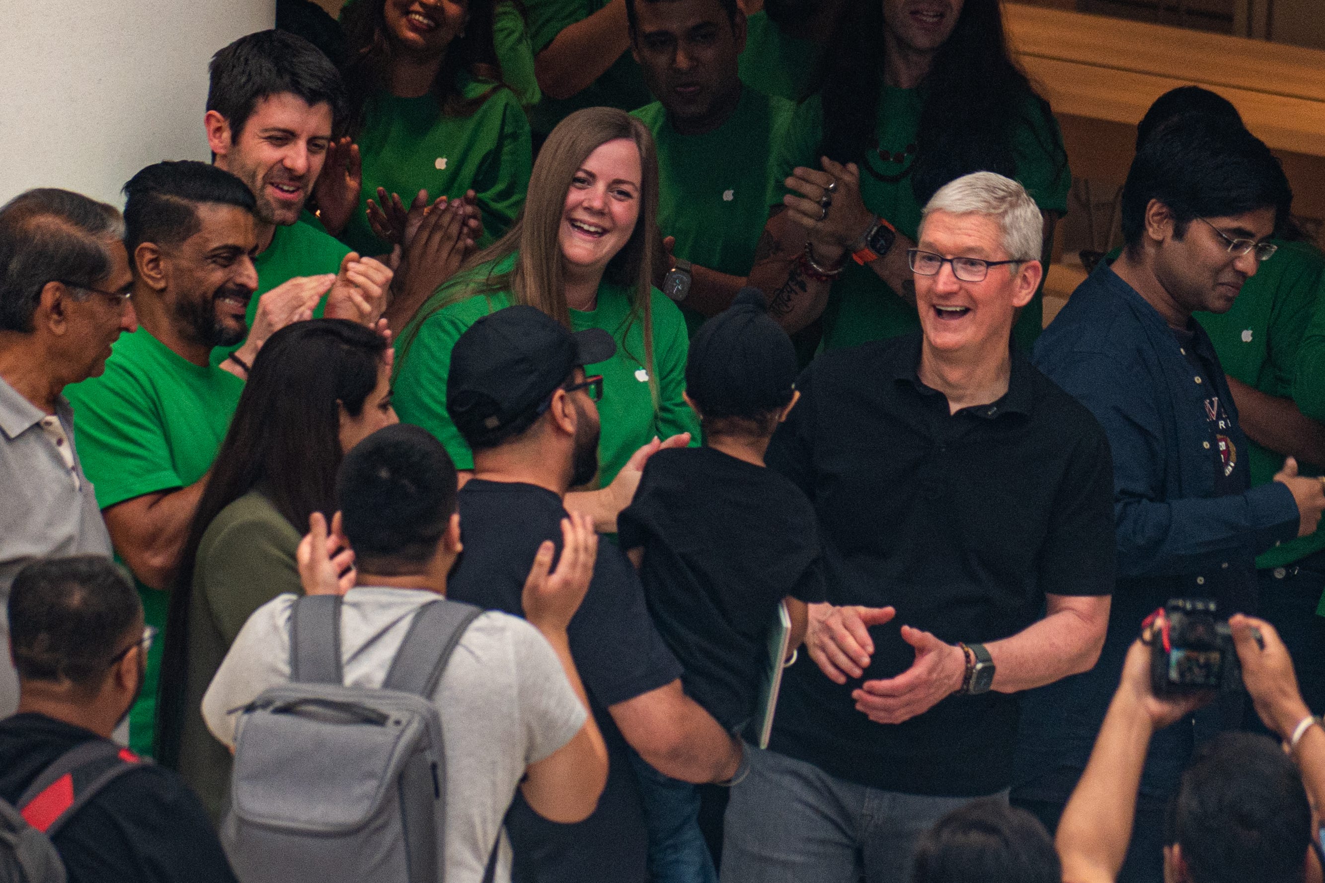 Apple Chief Executive Officer Tim Cook reacts to the crowd during the launch of the new Apple Inc. store in New Delhi, India