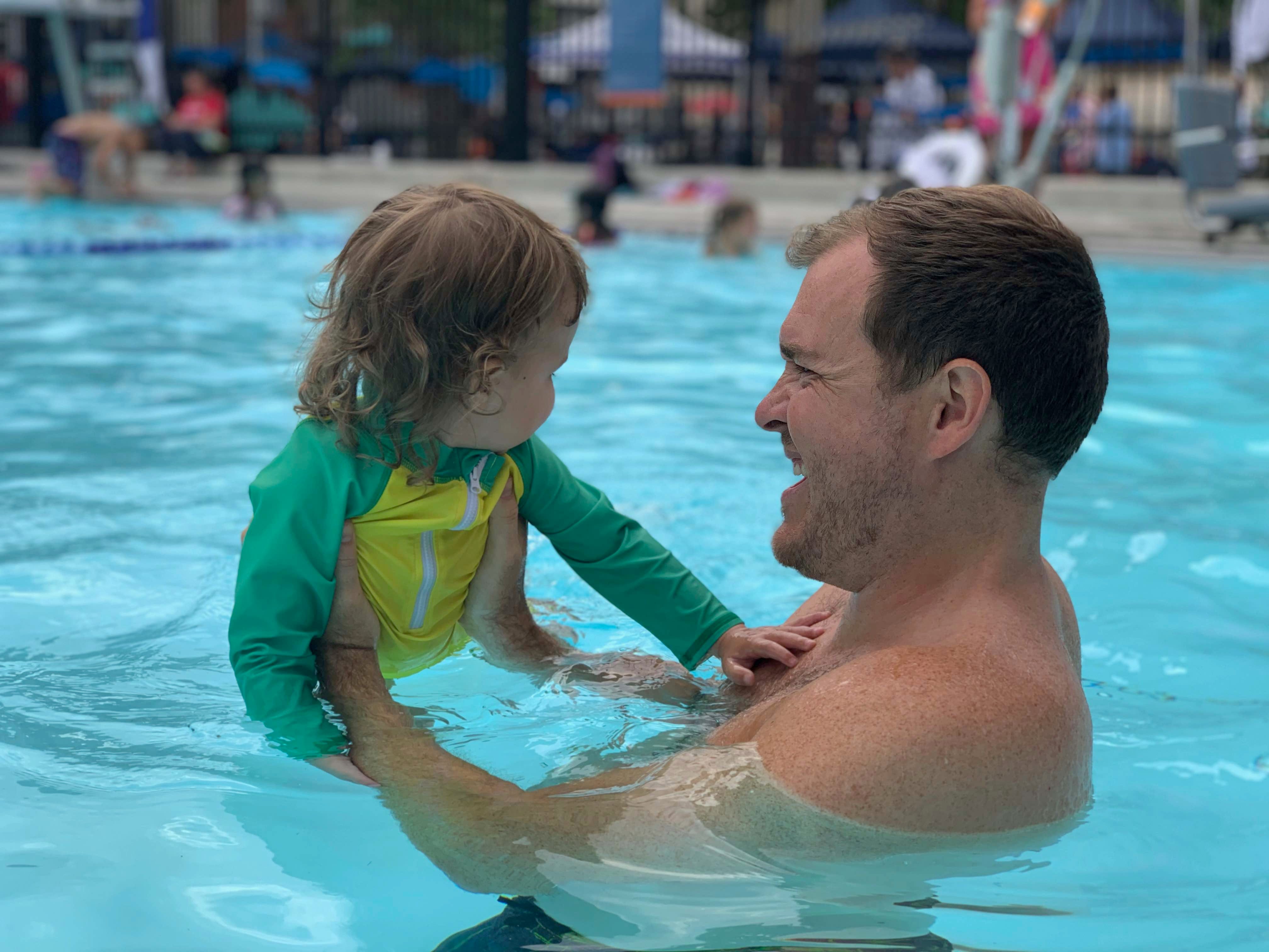 Christopher Wink and his kid in the pool