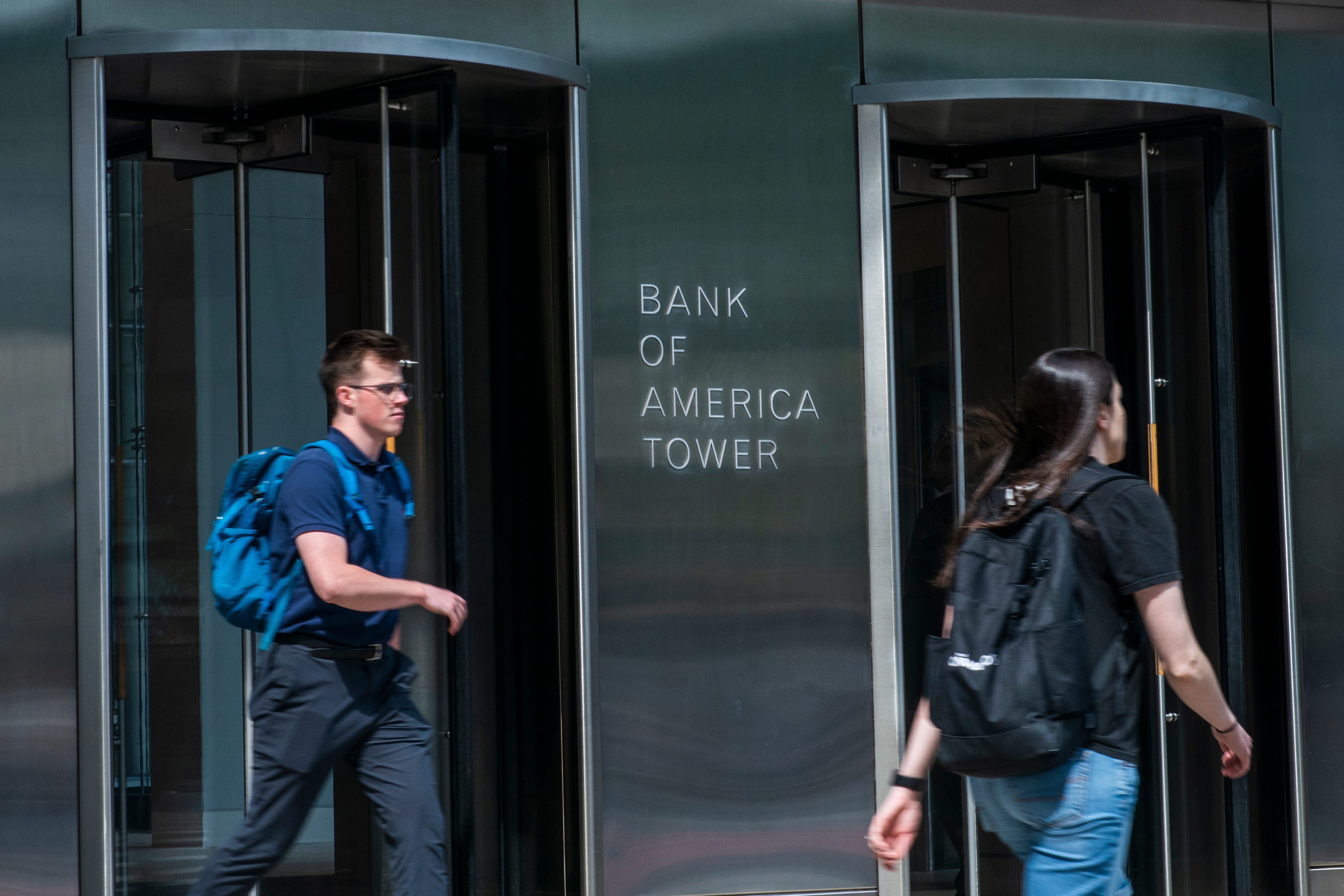 People walk by Bank of America