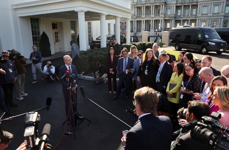 White House spokesperson Ian Sams speaks to reporters outside the White House in December.