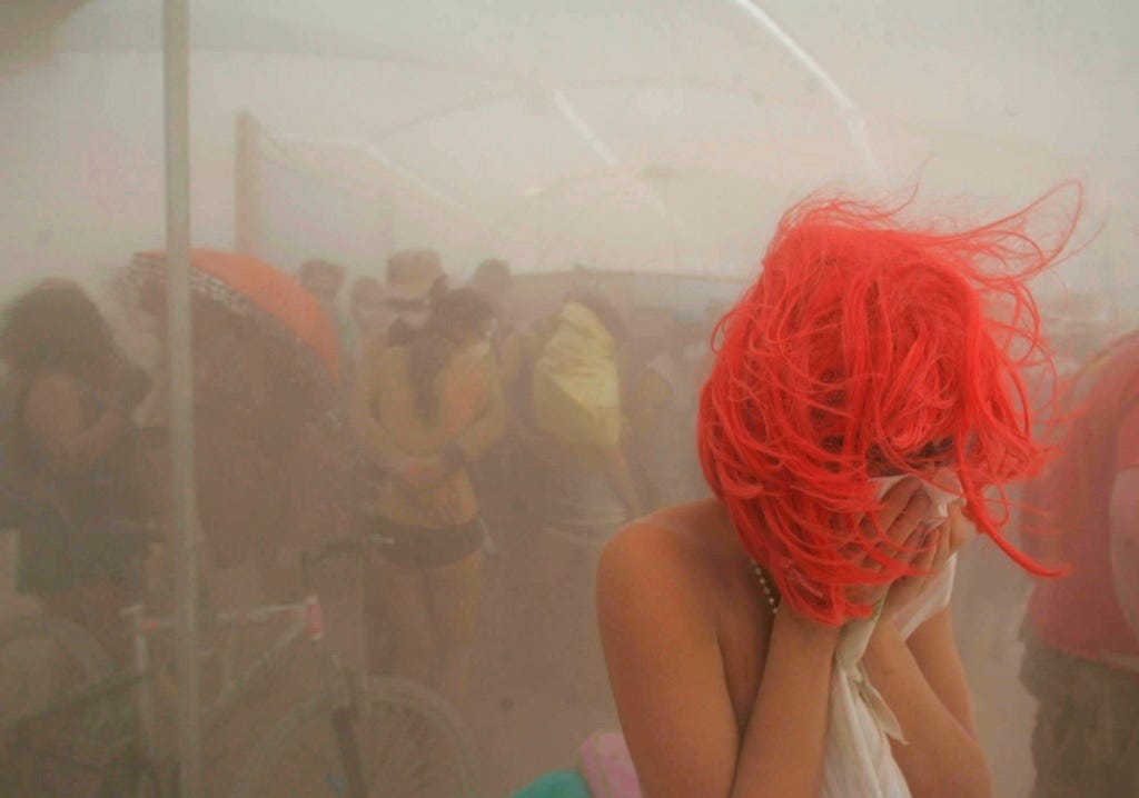 Woman covering her face in a dust storm