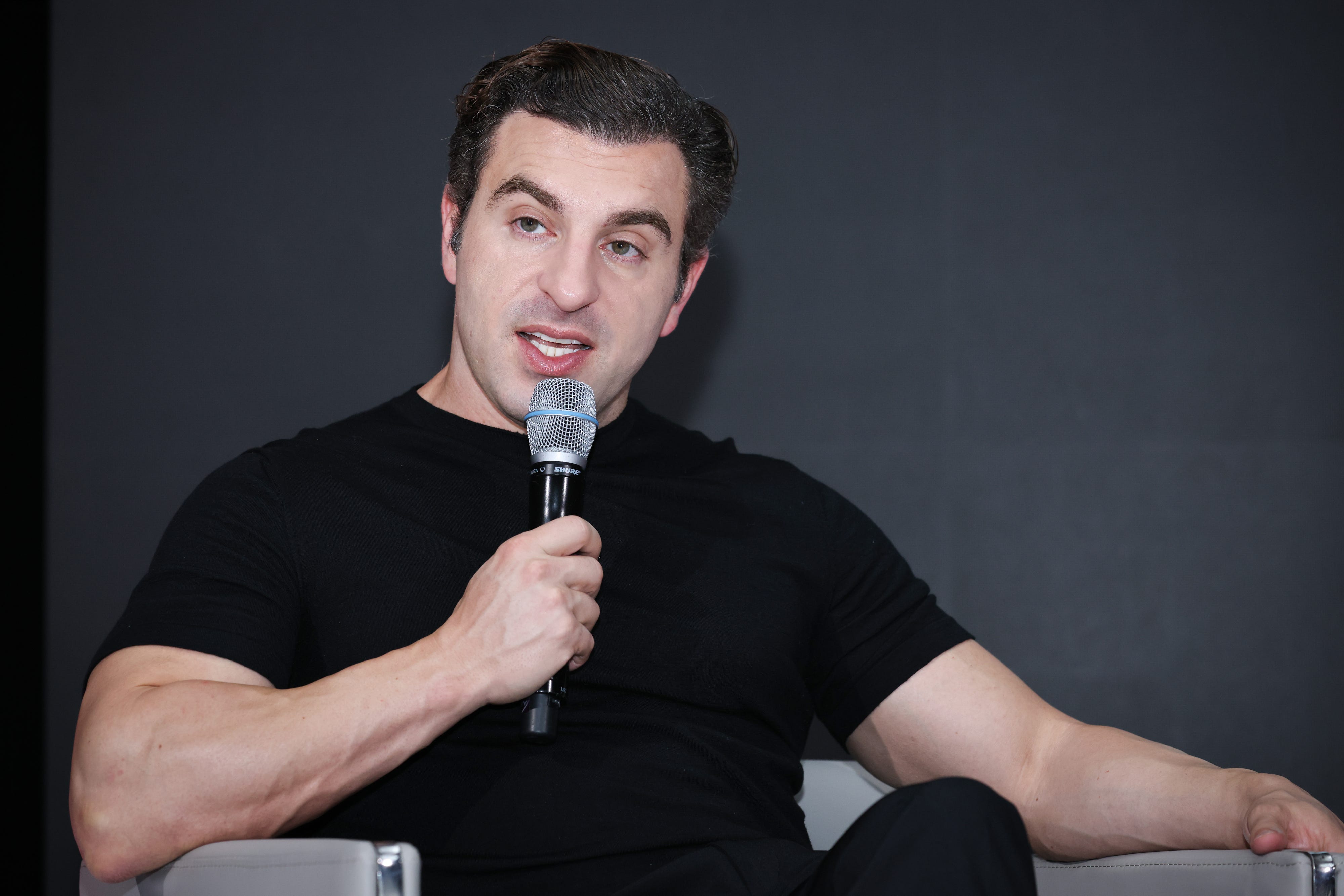 Brian Chesky speaking into a mic