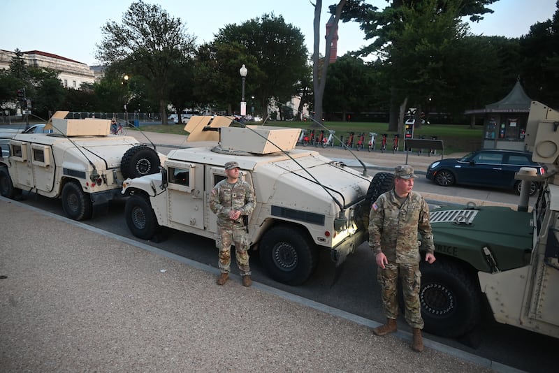 WASHINGTON, DC, UNITED STATES - AUGUST 12: Members of the DC National Guard assemble with military vehicles in front of the Washington Monument as part of President Trump's crime reduction efforts in the District of Columbia in Washington, DC, United States on August 12, 2025. (Photo by Kyle Mazza/Anadolu via Getty Images)
