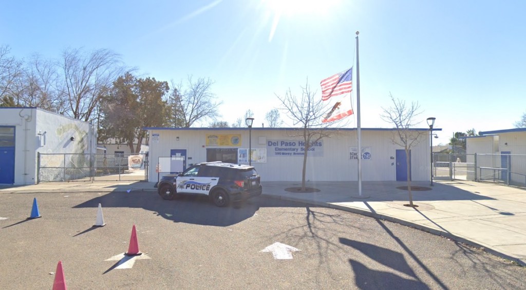 Del Paso Heights Elementary School building with a police car parked in front.