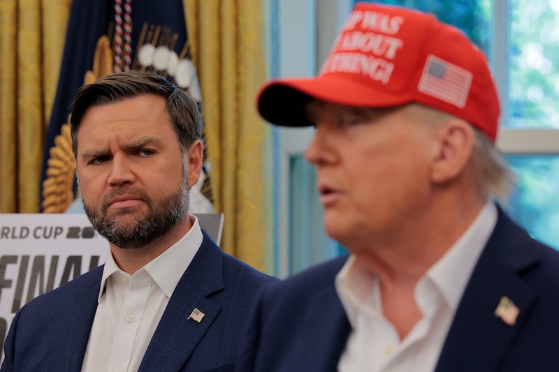 JD Vance looks at Donald Trump