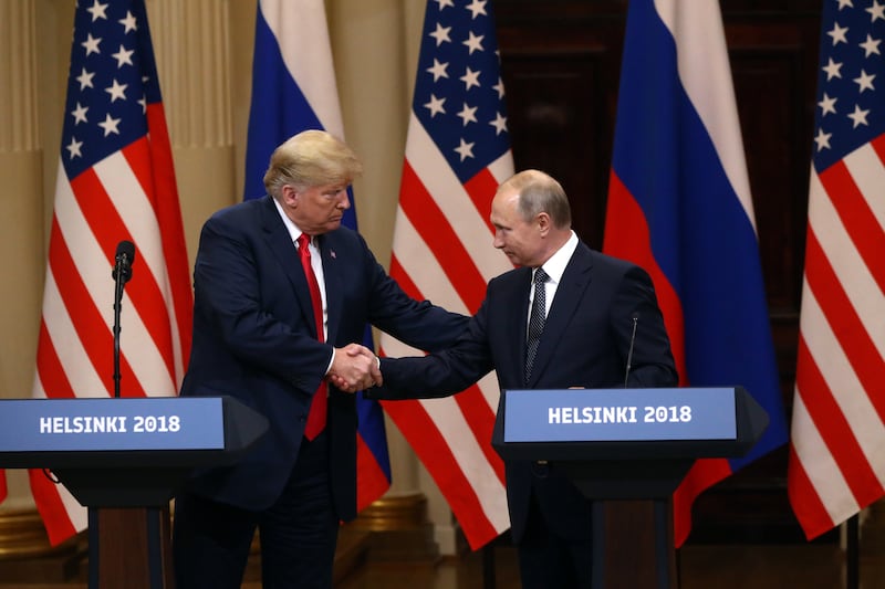 President Donald Trump (L) and Russian President Vladimir Putin shake hands during a joint press conference after their summit on July 16, 2018 in Helsinki, Finland.