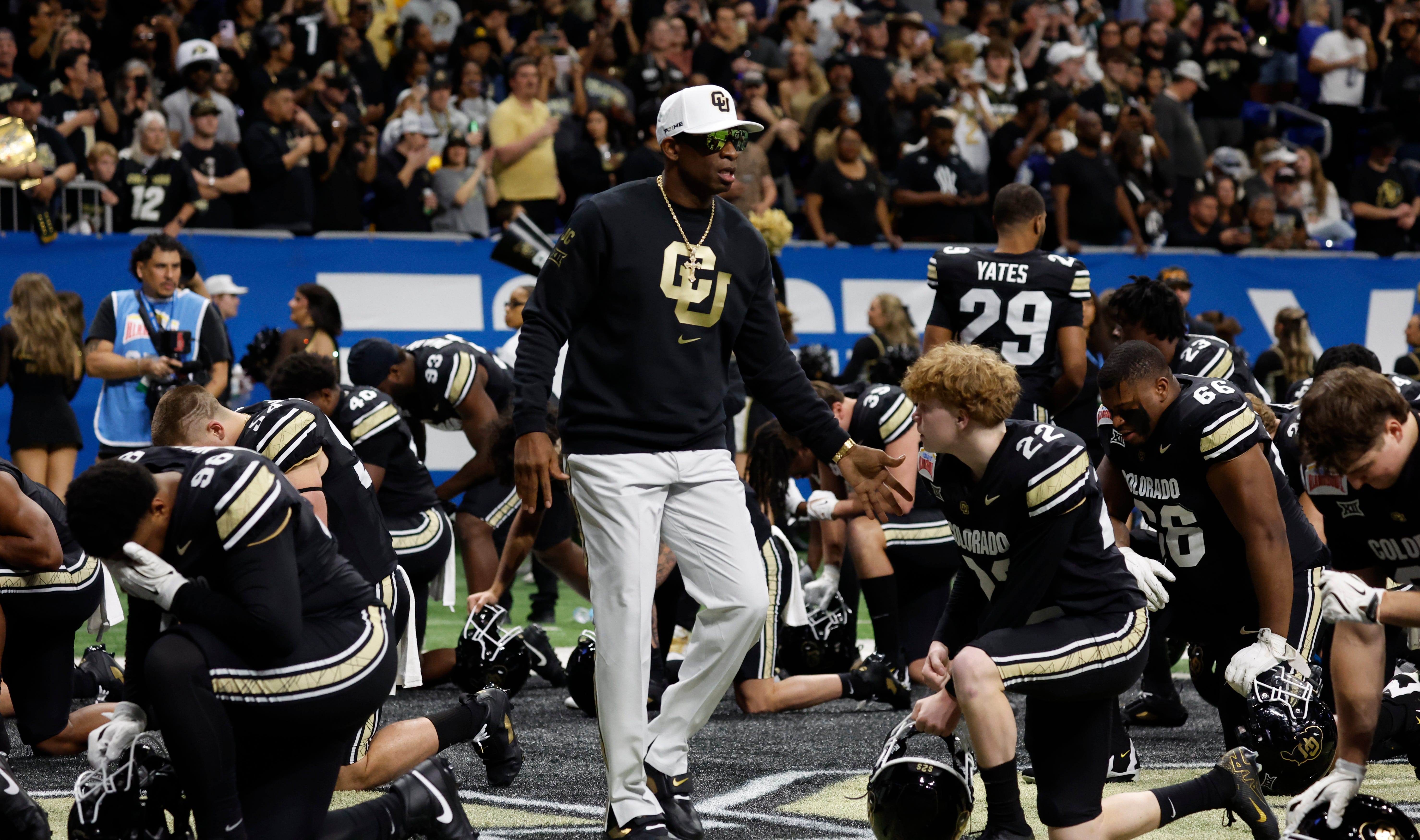 Deion Sanders, head coach of the Colorado Buffaloes, greets his team.