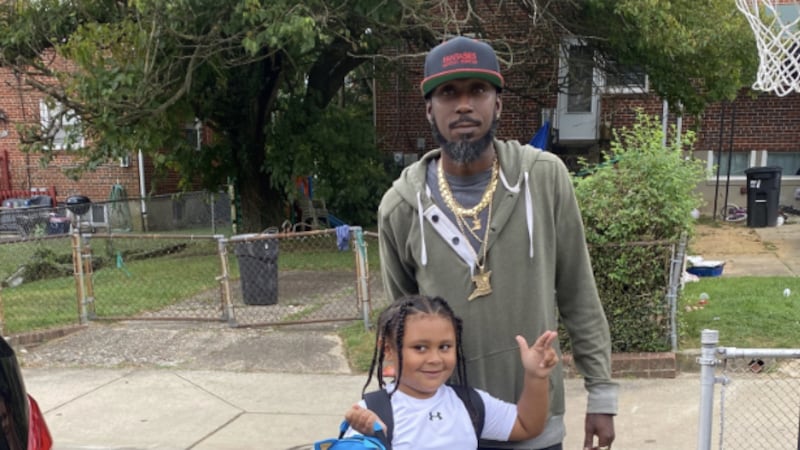 Deon Lewis with one of his kids.