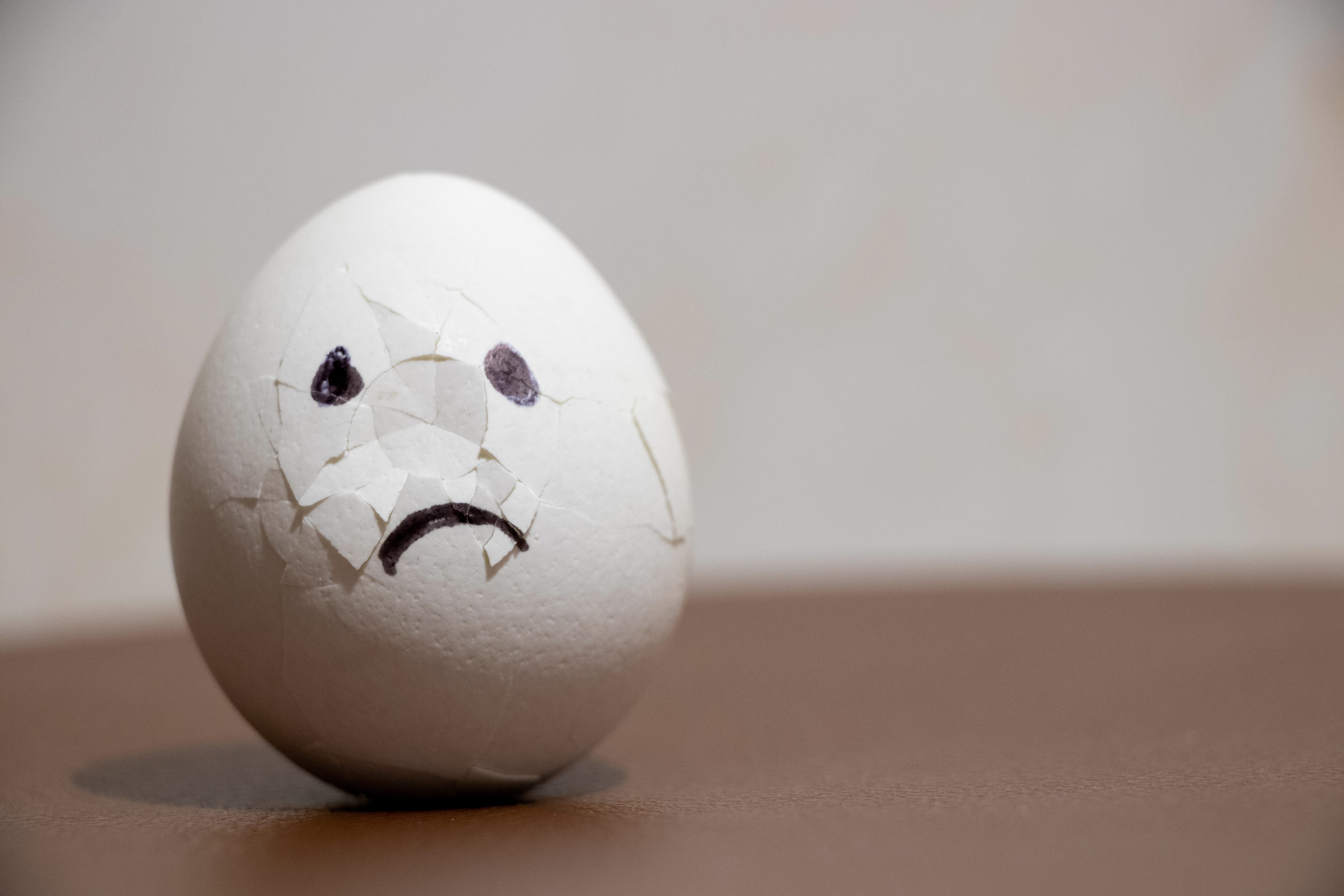 A sad cracked egg is pictured.