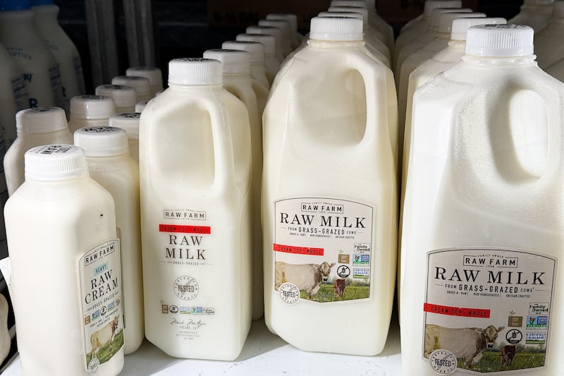 Raw milk bottles on a grocery store shelf