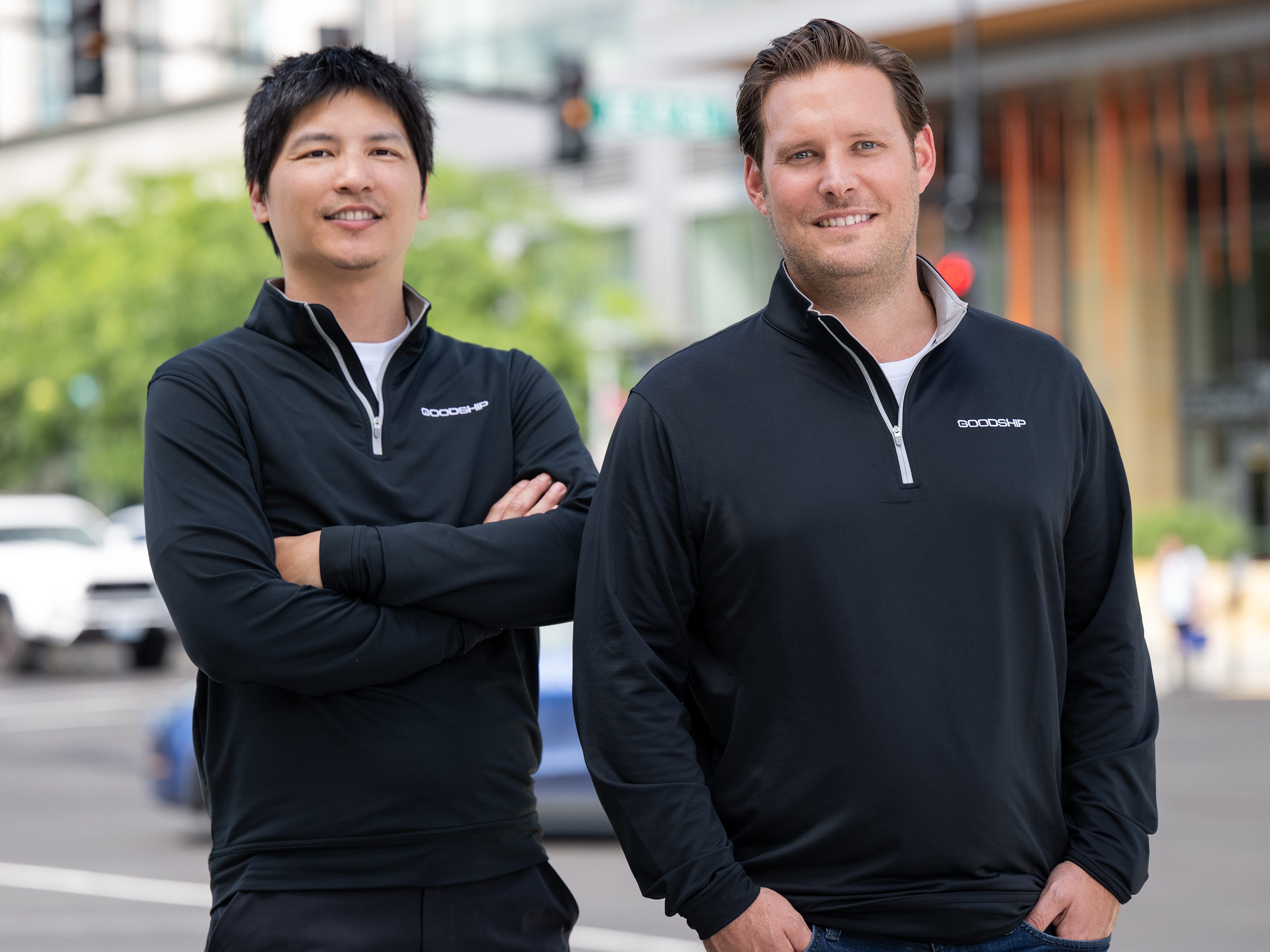 GoodShip founders David Tsai and Ryan Roskin, standing on the street and wearing zip-up hoodies with the company's logo.
