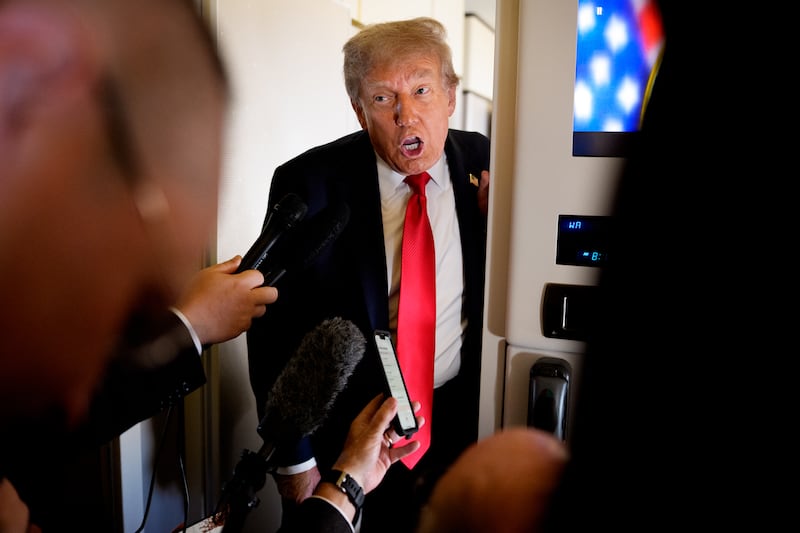 U.S. President Donald Trump speaks to members of the media aboard Air Force One on August 15, 2025, in flight. President Trump is traveling to Anchorage, Alaska, for peace talks with Russian President Vladimir Putin on the war with Ukraine. (Photo by Andrew Harnik/Getty Images)