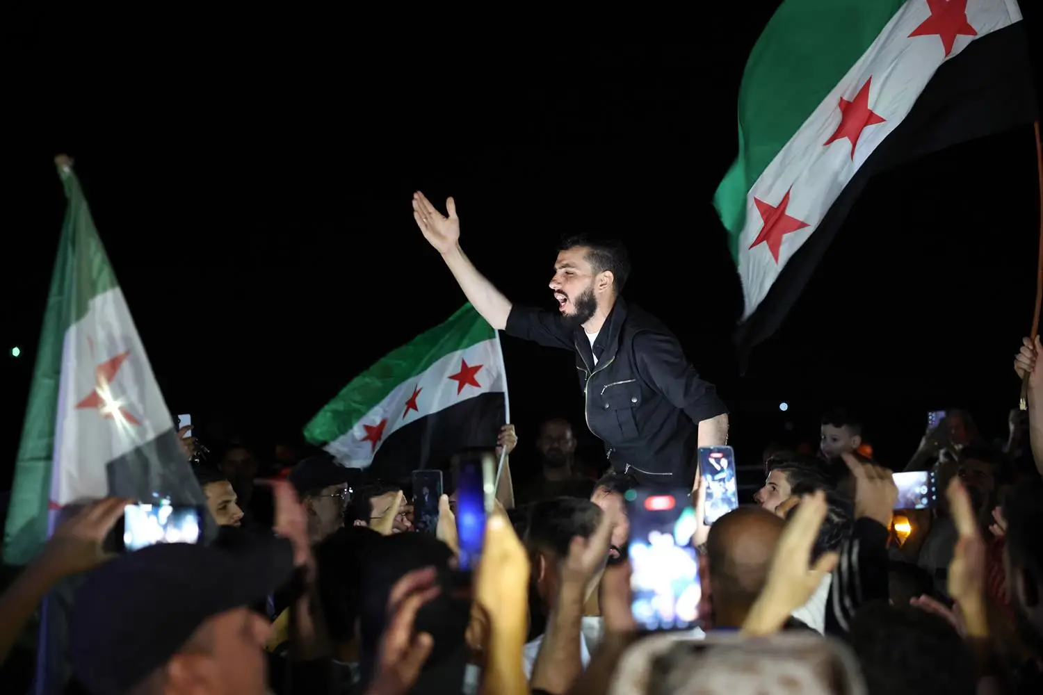 Syrians mark the 12th anniversary of former leader Bashar al-Assad’s 2013 chemical attack on Ghouta, seen in Zamalka, Syria, on Aug. 21.
