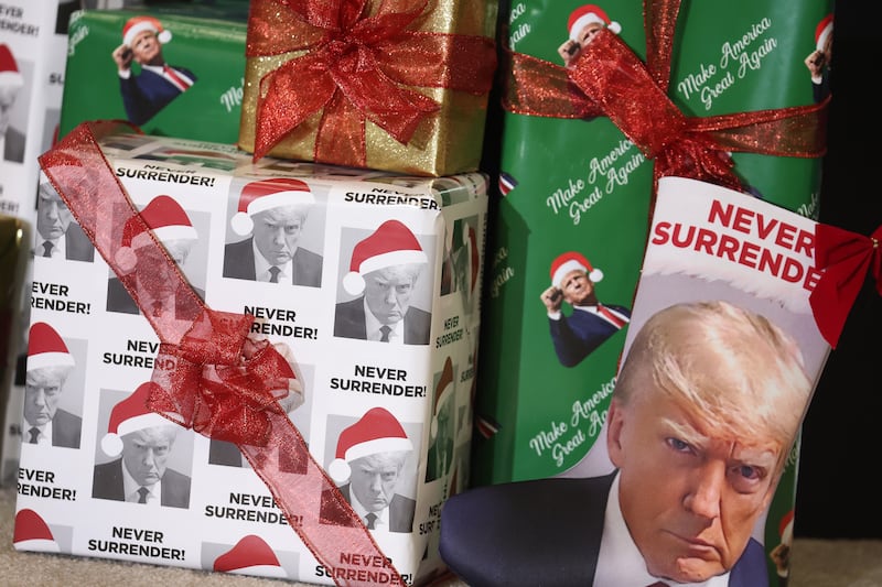 Gifts wrapped in Christmas wrapping paper featuring the likeness of Republican presidential candidate former U.S. President Donald Trump sit on the stage during a rally hosted by the former president on December 19, 2023 in Waterloo, Iowa. Iowa Republicans will be the first to select their party's nomination for the 2024 presidential race, when they go to caucus on January 15, 2024. (Photo by Scott Olson/Getty Images)