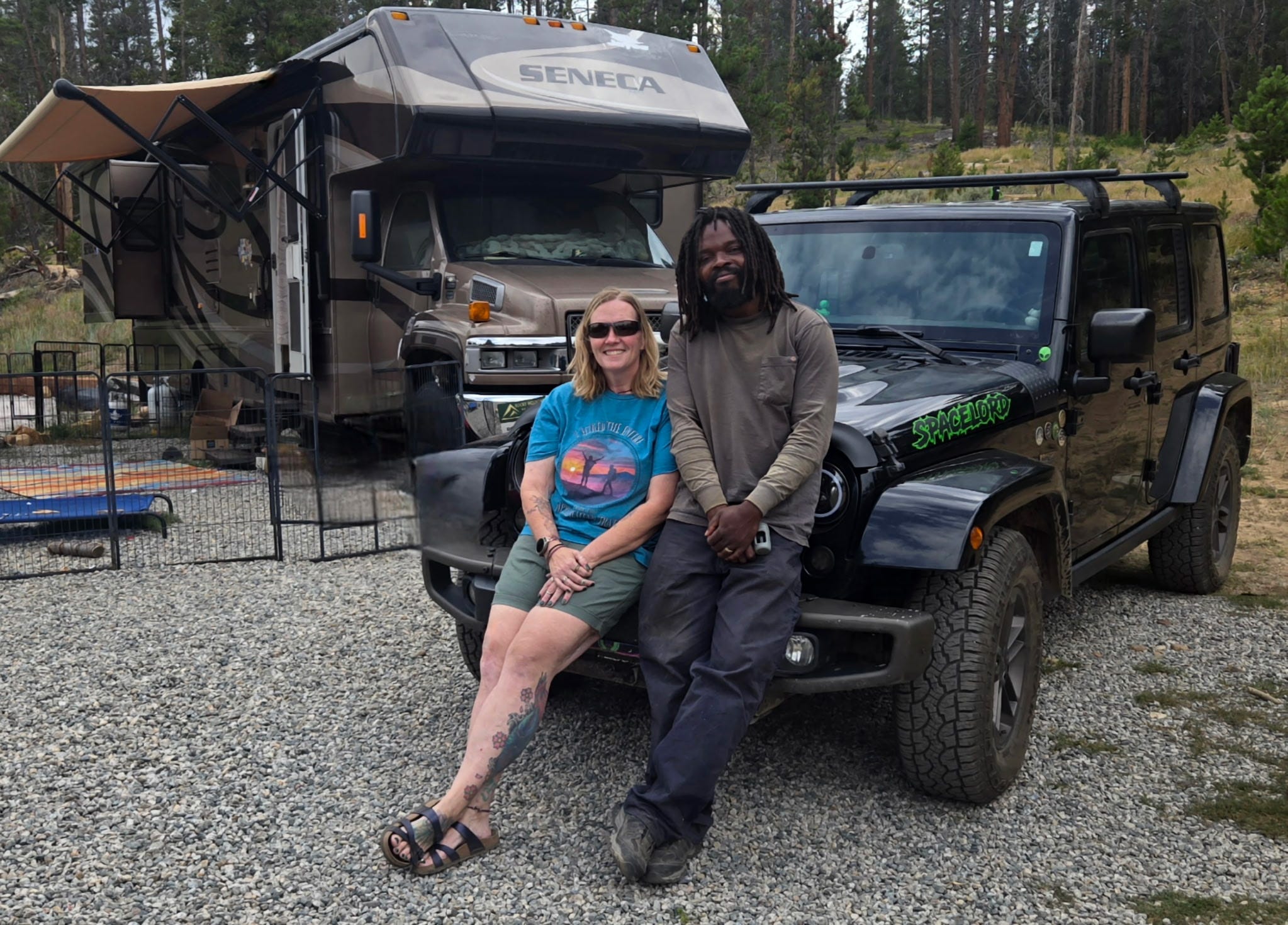 Victoria Childers and Lamont Landrum with their RV and Jeep at a campground.