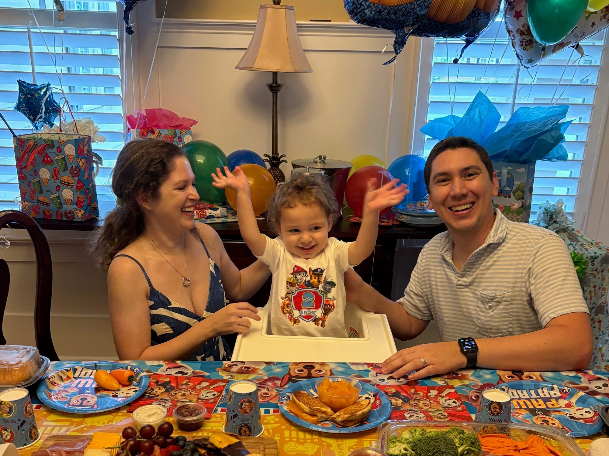 The author with her husband and son, in front of a lunch spread at a dining table.