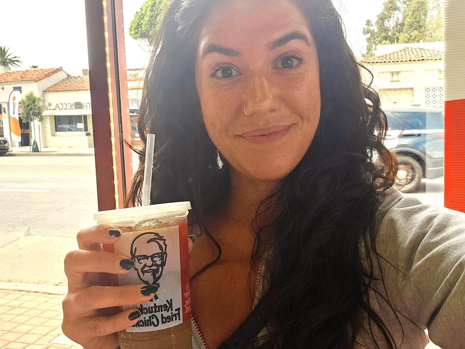 The author takes a selfie with her drink from KFC.