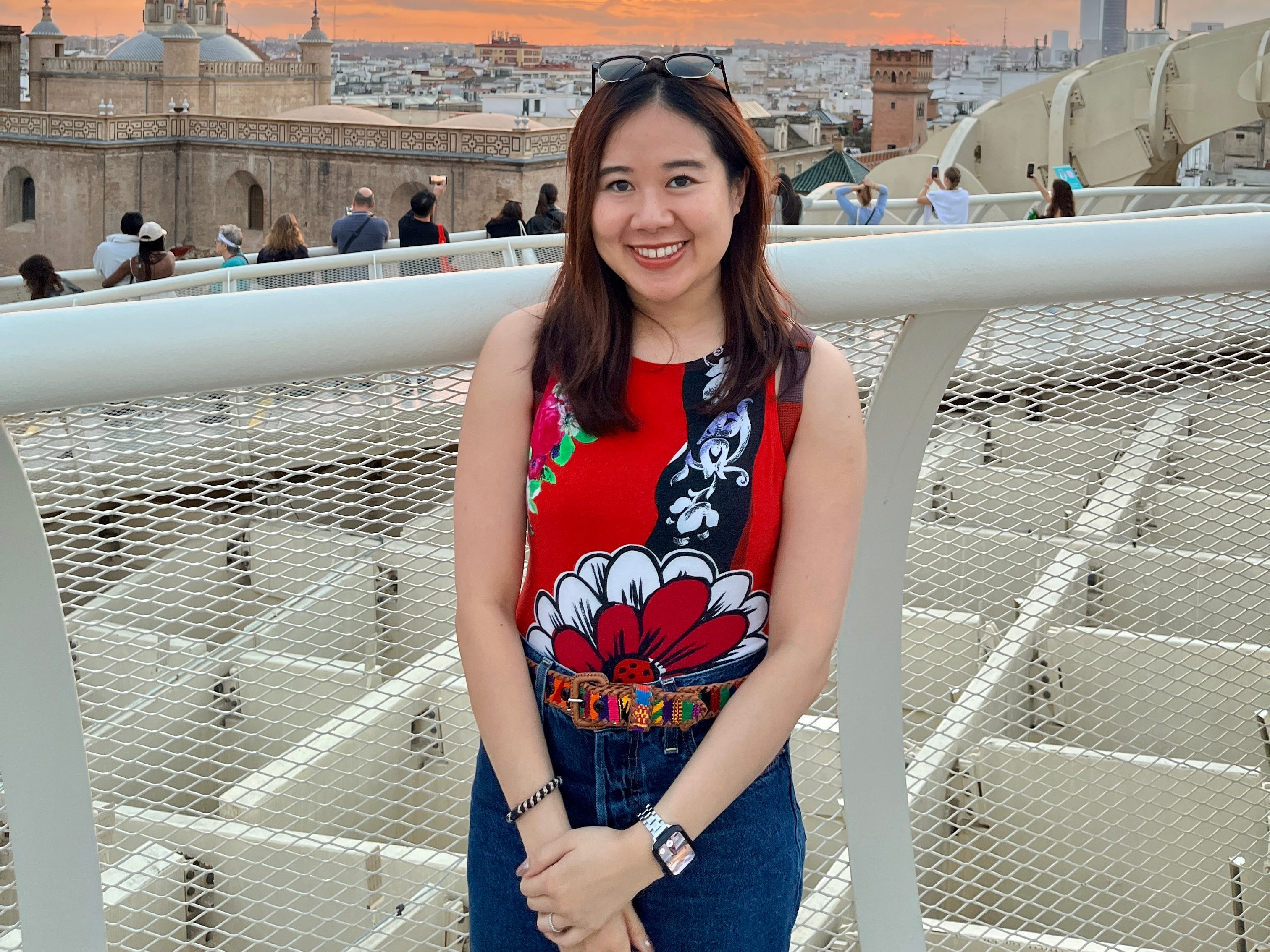 Annie Lu posing in front of a tourist attraction in Spain.