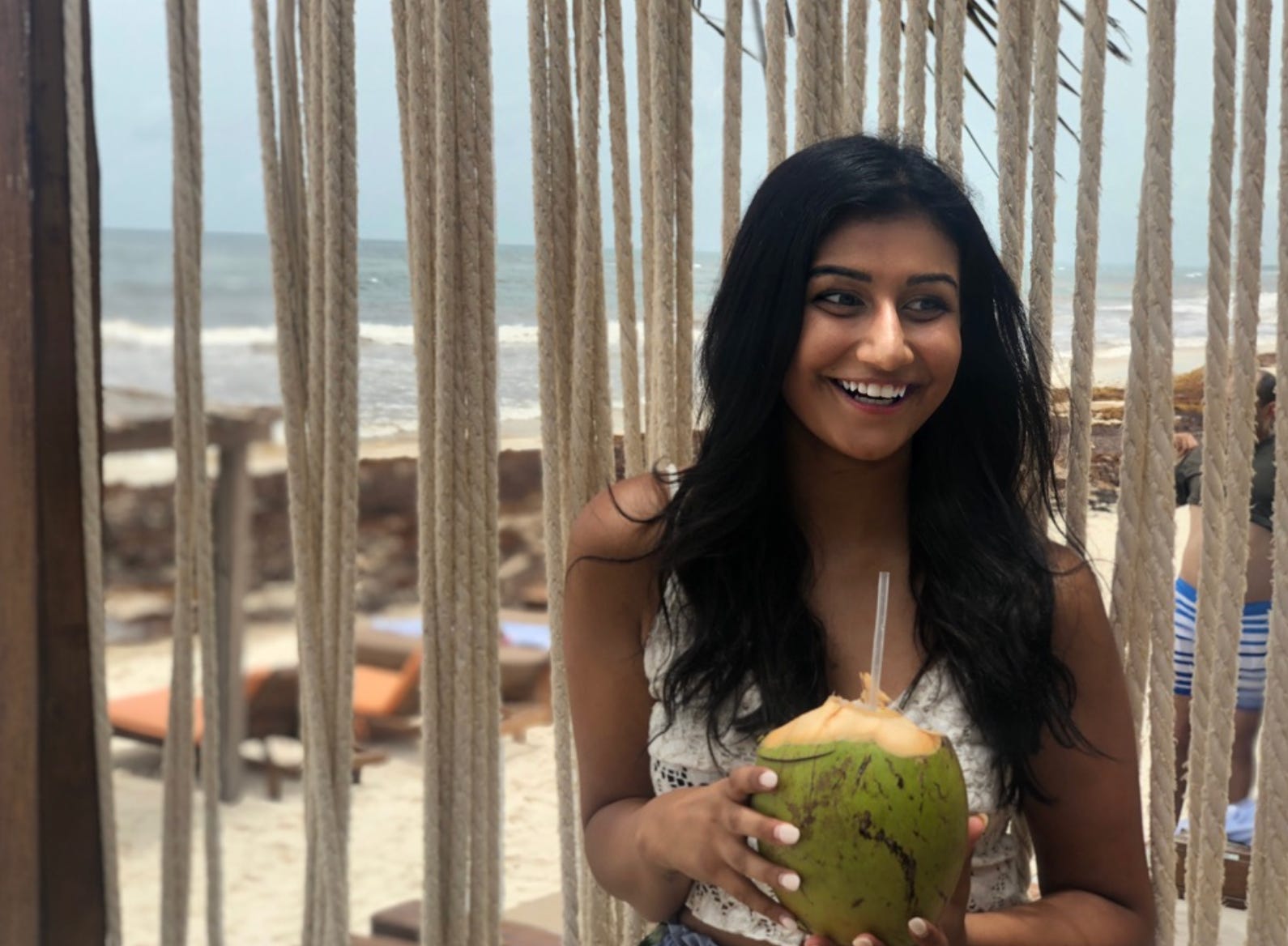 The writer drinking out of a coconut in Mexico.