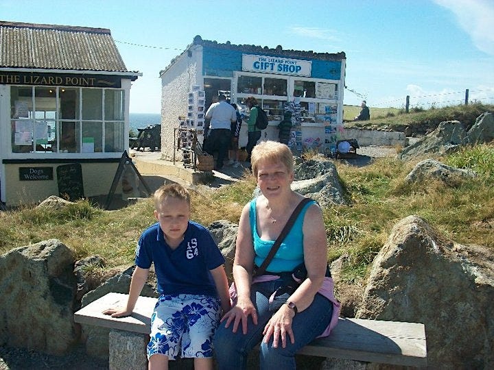 The author with his grandmother when they were young in front of a gift shop.