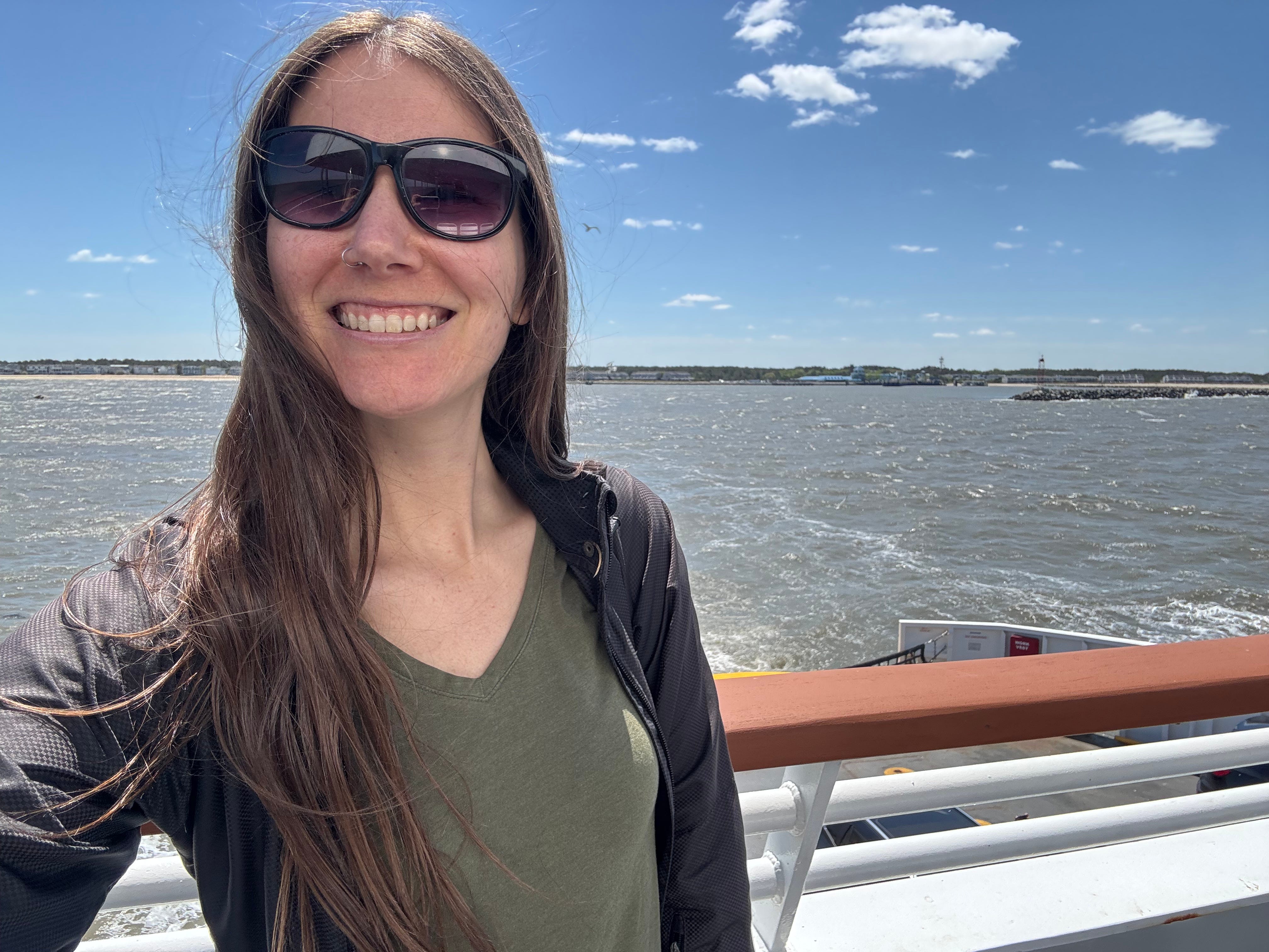 Jane takes a selfie on an outdoor ferry deck.