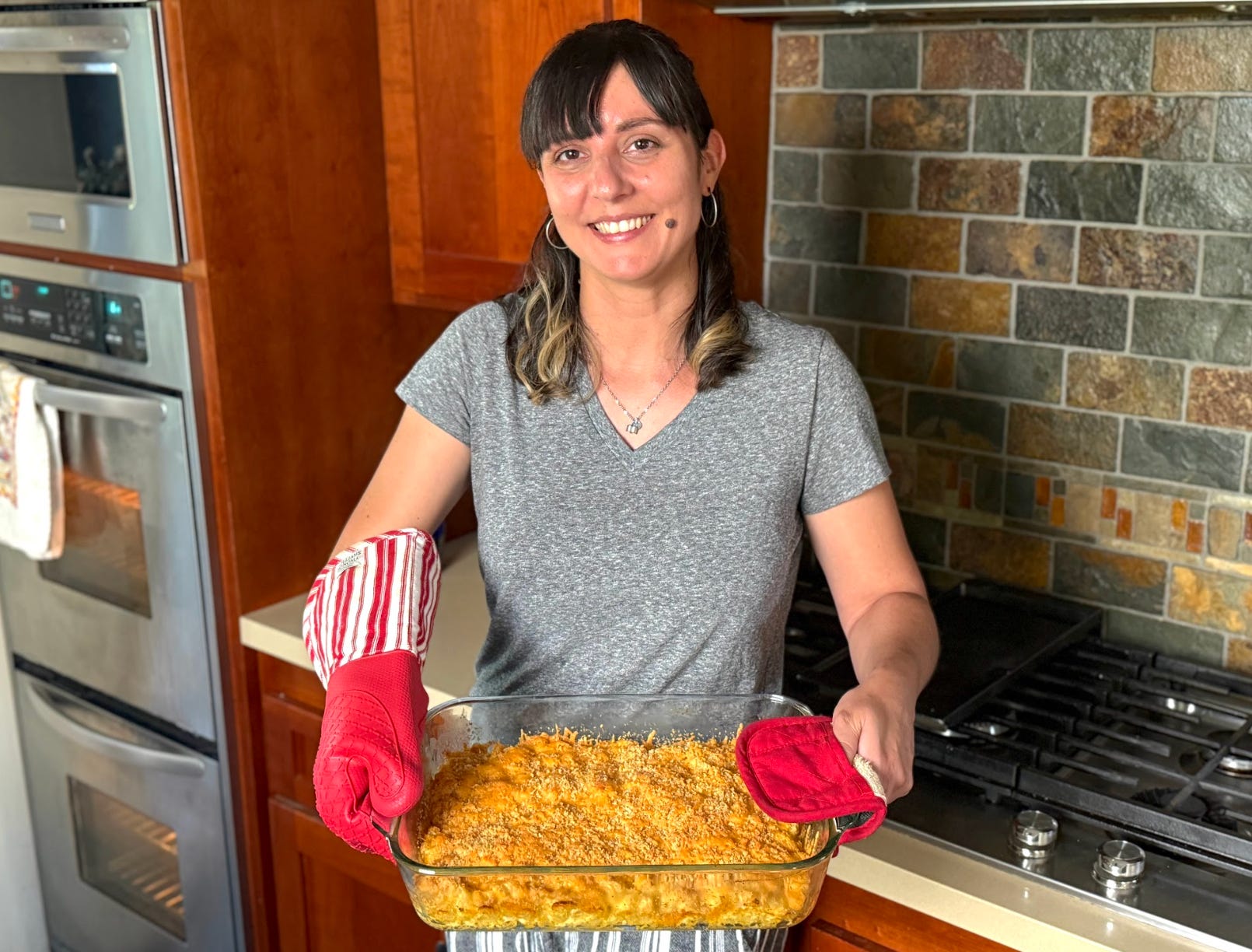 The writer holding Ree Drummond's mac and cheese after following her recipe.